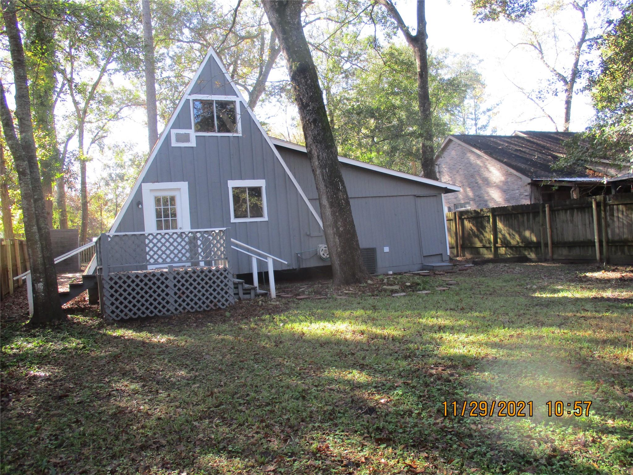 Backyard view looking at Back of House - If you have additional questions regarding 105 Lazy Trail  in Conroe or would like to tour the property with us call 800-660-1022 and reference MLS# 89335860.