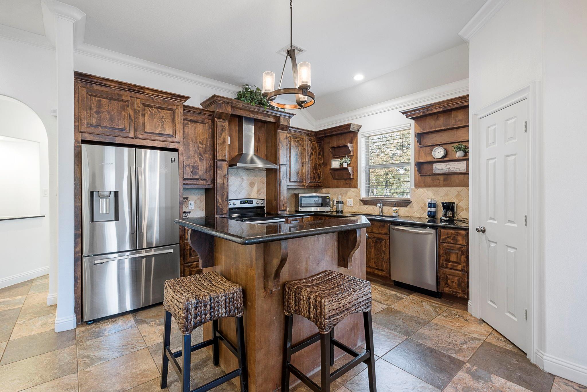 Open concept kitchen with breakfast bar and stainless steel appliances - If you have additional questions regarding 1155 Whipporwill Road  in Conroe or would like to tour the property with us call 800-660-1022 and reference MLS# 12122183.