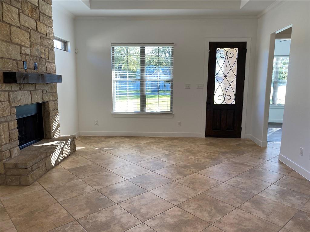 Living room with tile flooring, fireplace and tray ceiling - If you have additional questions regarding 710 W Lockhart Street  in Kyle or would like to tour the property with us call 800-660-1022 and reference MLS# 5441365.