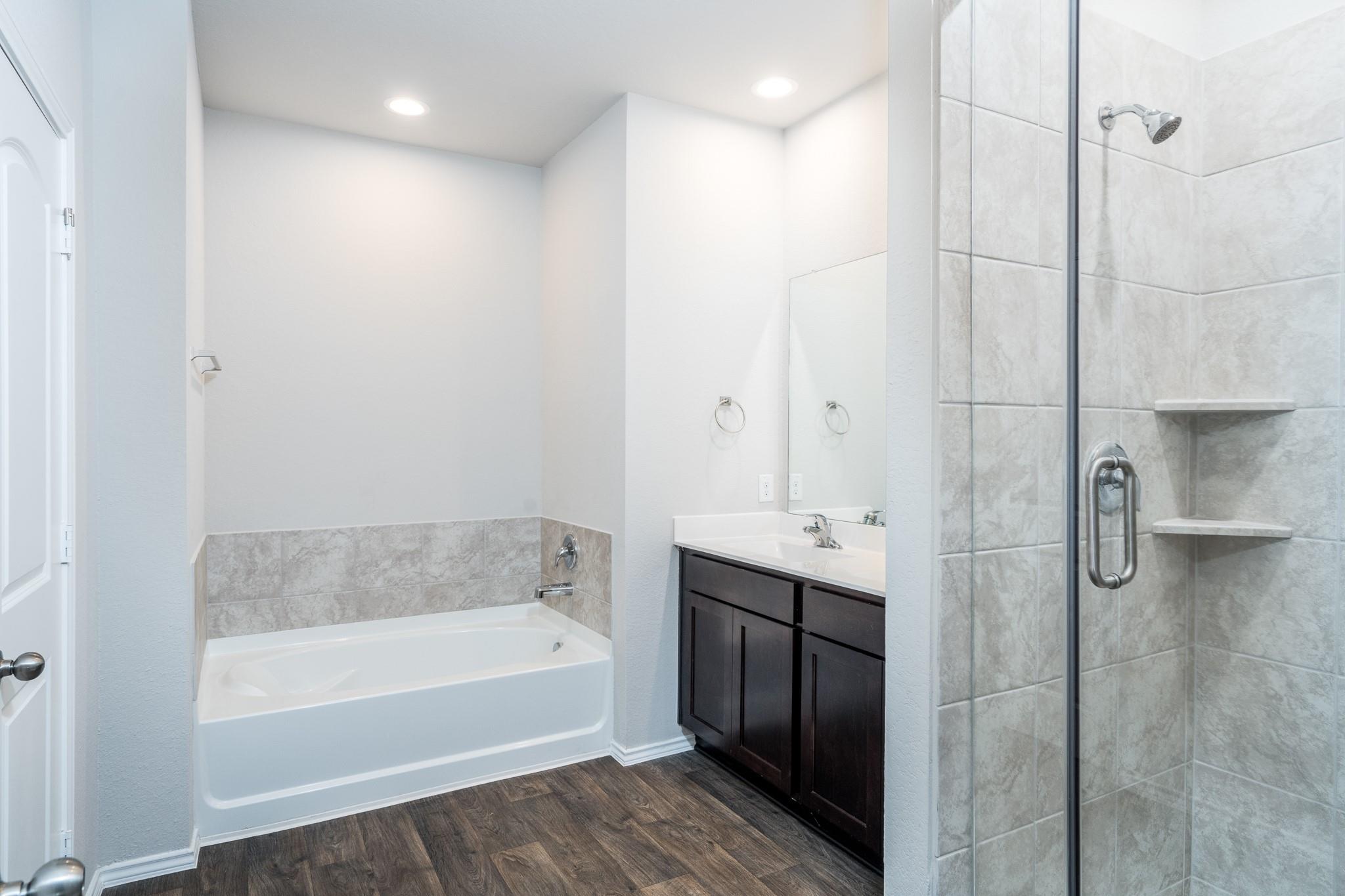 Master bath with double sink and separate tub and shower - If you have additional questions regarding 6513 Wild Cilliment Court  in Conroe or would like to tour the property with us call 800-660-1022 and reference MLS# 88190472.