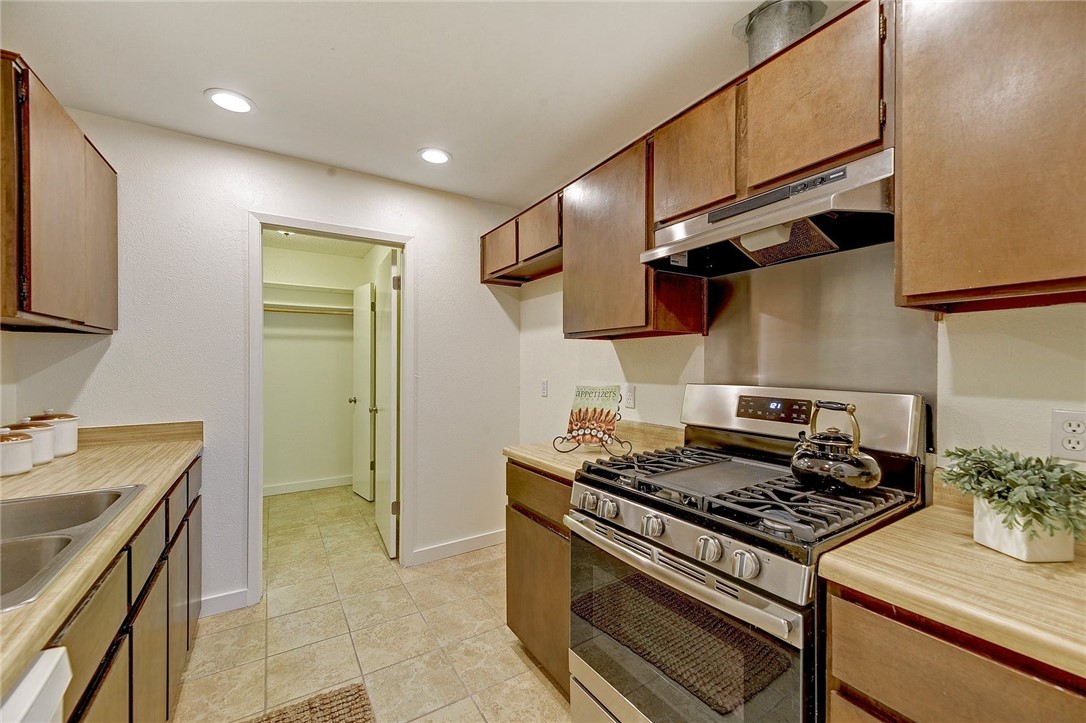 View of kitchen and combination pantry/ laundry room. - If you have additional questions regarding 7603 Whispering Winds Drive  in Austin or would like to tour the property with us call 800-660-1022 and reference MLS# 1592502.