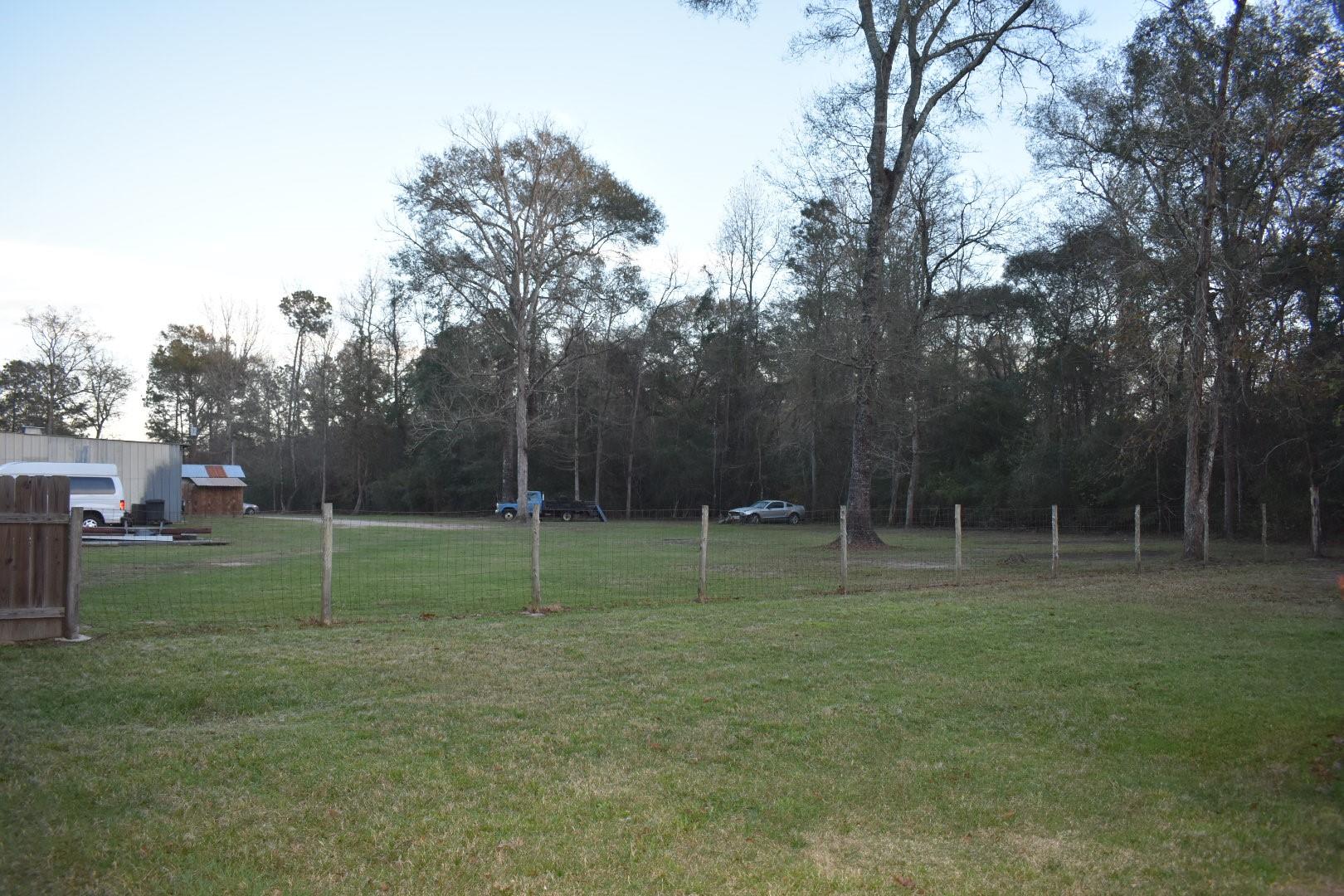 Standing in back field looking toward the shop - If you have additional questions regarding 14840 Kyle Lane  in Conroe or would like to tour the property with us call 800-660-1022 and reference MLS# 54506033.