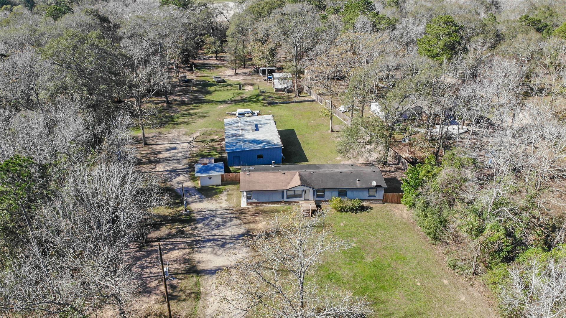 This property is listed at land/shop value only.  Here you can see the 4/2 mobile, well house and 30x60 shop. The 24x24 barn is located toward the back right. - If you have additional questions regarding 14840 Kyle Lane  in Conroe or would like to tour the property with us call 800-660-1022 and reference MLS# 54506033.