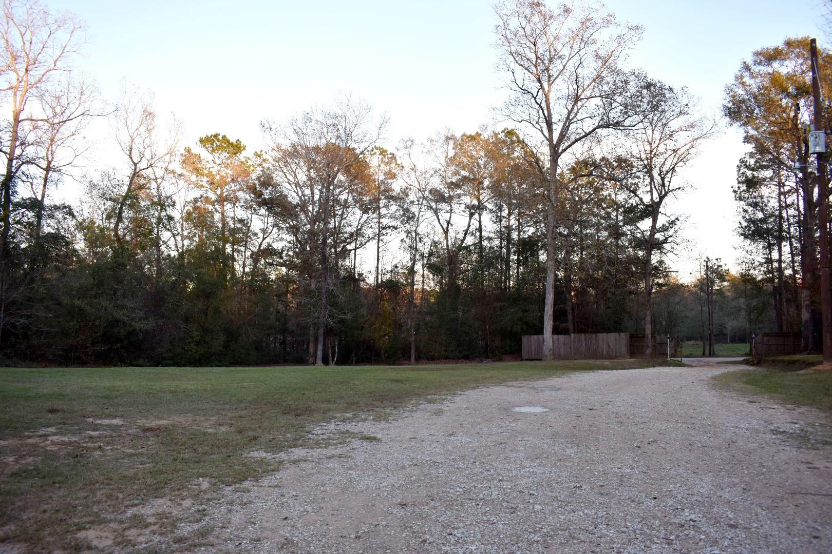 Looking toward the road and gate entrance - If you have additional questions regarding 14840 Kyle Lane  in Conroe or would like to tour the property with us call 800-660-1022 and reference MLS# 54506033.