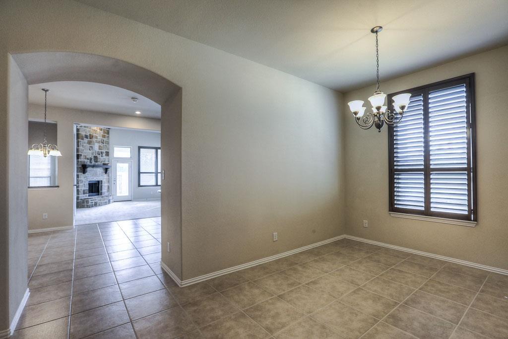 Looking toward the back of the home. The dining room has custom shutters and tile flooring. - If you have additional questions regarding 8206 Laughing Falcon Trail  in Conroe or would like to tour the property with us call 800-660-1022 and reference MLS# 26206209.