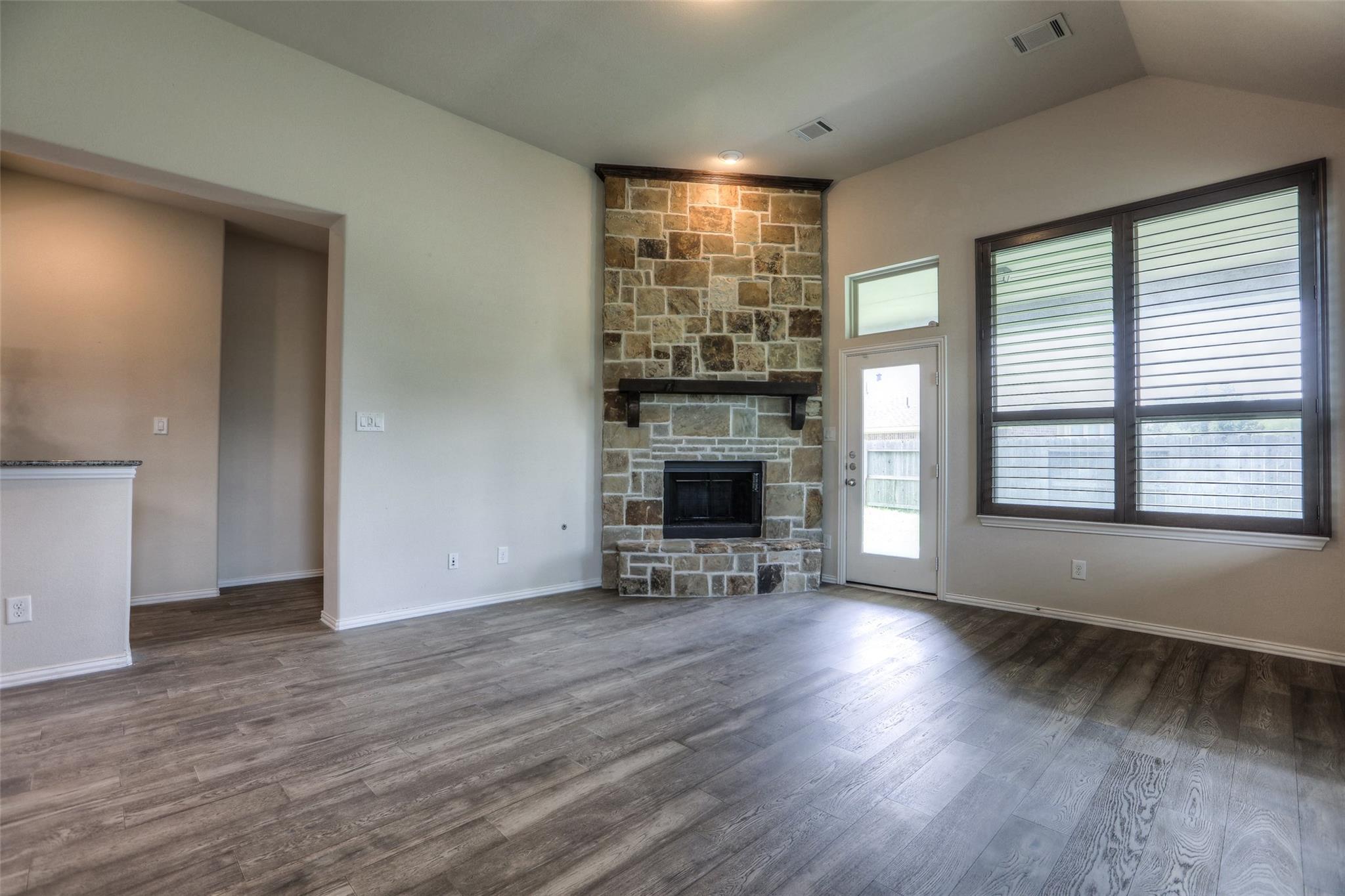 This view of the family room shows the fireplace as a focal point. The hall to the left leads to the master. - If you have additional questions regarding 8206 Laughing Falcon Trail  in Conroe or would like to tour the property with us call 800-660-1022 and reference MLS# 26206209.