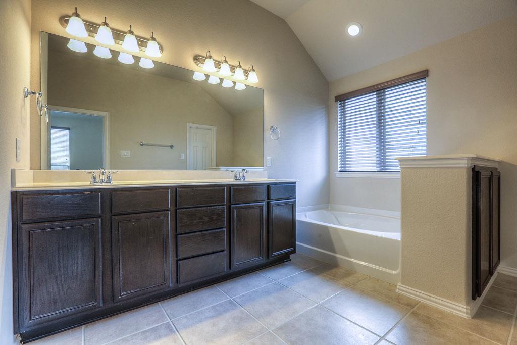 Plenty of room for everyone to get ready in this master bathroom! Additional storage cabinet on the right. - If you have additional questions regarding 8206 Laughing Falcon Trail  in Conroe or would like to tour the property with us call 800-660-1022 and reference MLS# 26206209.