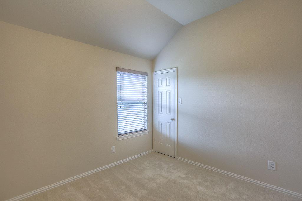 A bedroom upstairs with a walk in closet and an attached bathroom is perfect for guests or family. - If you have additional questions regarding 8206 Laughing Falcon Trail  in Conroe or would like to tour the property with us call 800-660-1022 and reference MLS# 26206209.