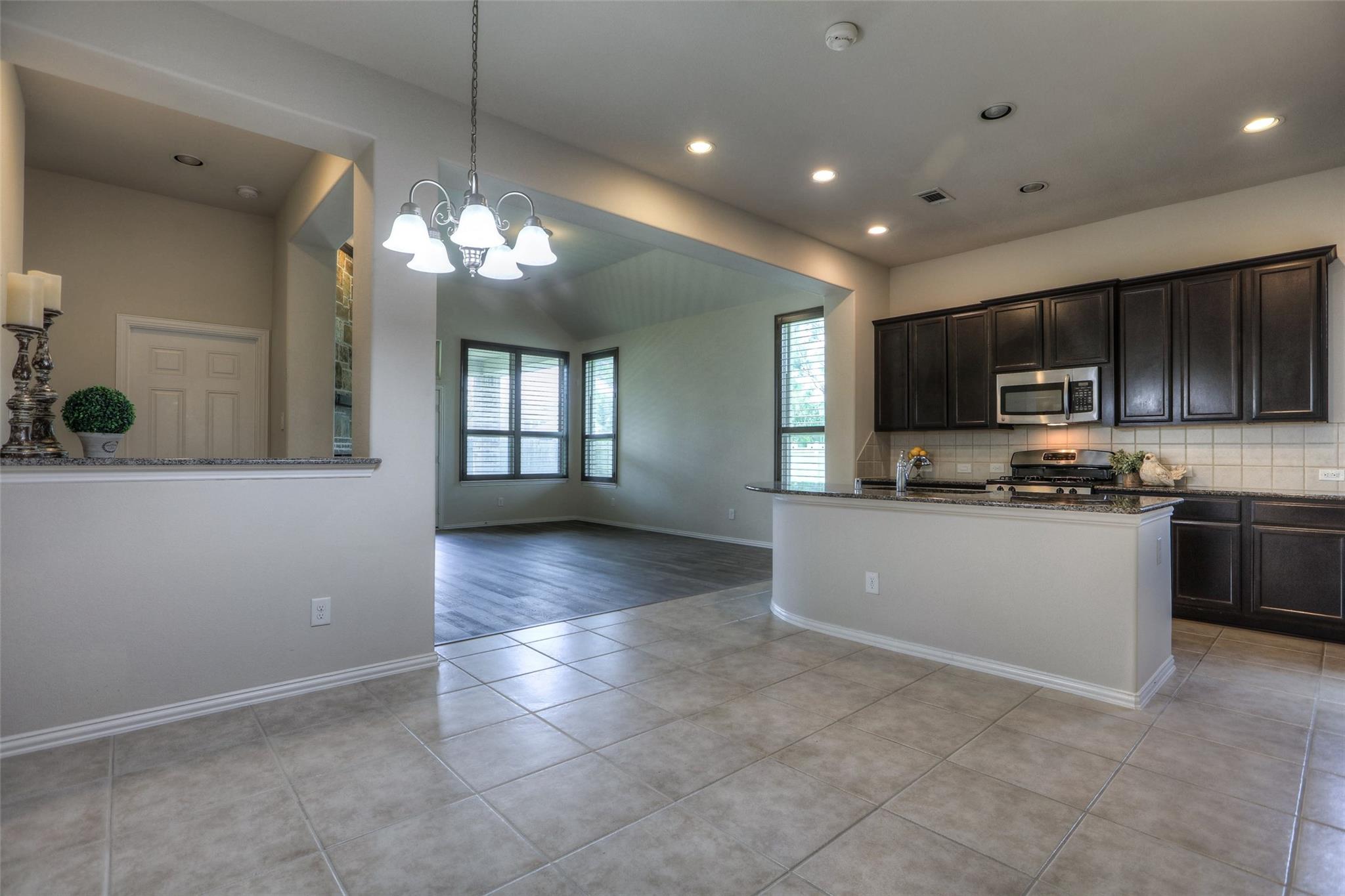The breakfast area looking toward the kitchen and family room. The door to the master is on the left. - If you have additional questions regarding 8206 Laughing Falcon Trail  in Conroe or would like to tour the property with us call 800-660-1022 and reference MLS# 26206209.
