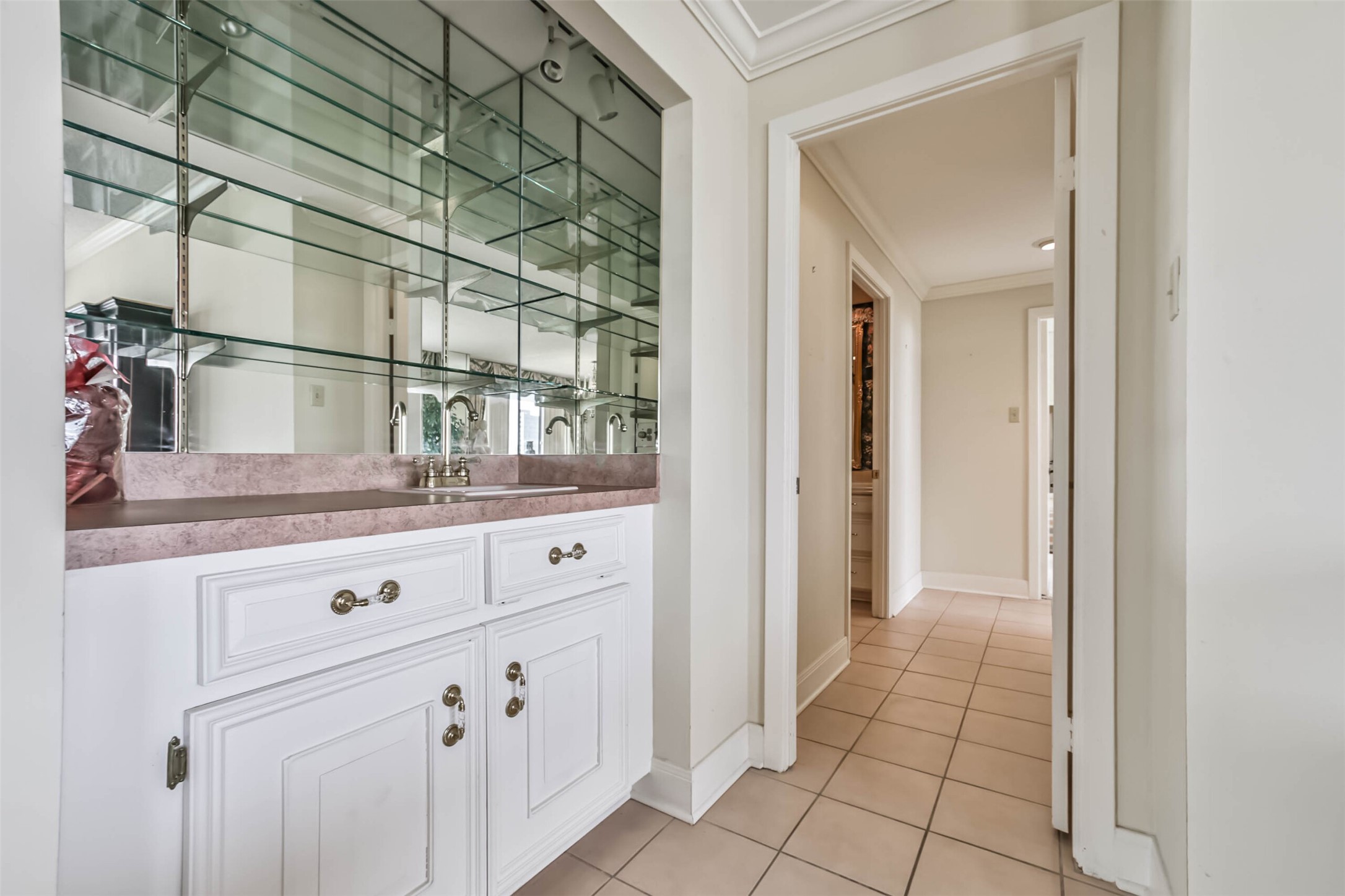 Just off the living room is a wet bar, complete with glass shelves to display your favorite drinkware. - If you have additional questions regarding 49 Briar Hollow Lane  in Houston or would like to tour the property with us call 800-660-1022 and reference MLS# 67039242.