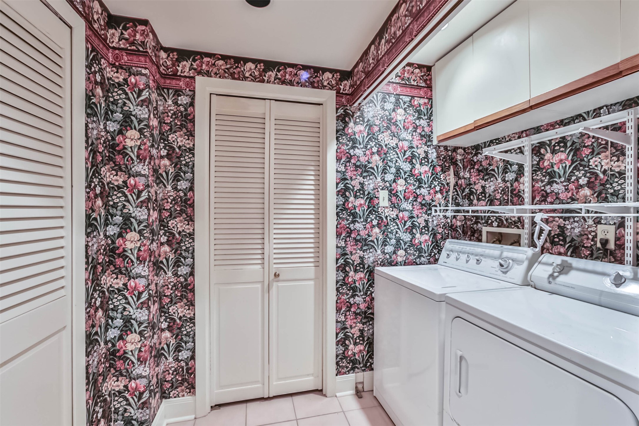 Located inside the guest bathroom is a large laundry room with storage both above and across the room.  Storage is abundant here and through the door shown straight ahead is a very large closet! - If you have additional questions regarding 49 Briar Hollow Lane  in Houston or would like to tour the property with us call 800-660-1022 and reference MLS# 67039242.