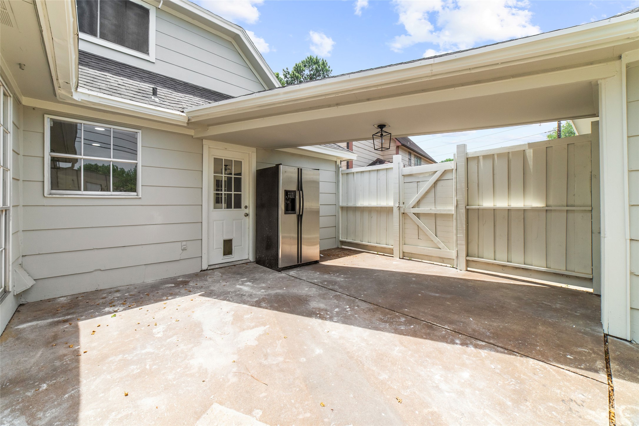 Back patio with covered walkway to detached garage - If you have additional questions regarding 22506 Wetherburn Lane  in Katy or would like to tour the property with us call 800-660-1022 and reference MLS# 96980135.