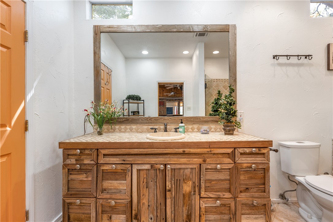 Main house bath has wood cabinetry, tile counter tops, single vanity, walk in shower & jacuzzi bathtub. - If you have additional questions regarding 16301 E Lake Shore Drive  in Austin or would like to tour the property with us call 800-660-1022 and reference MLS# 7548762.