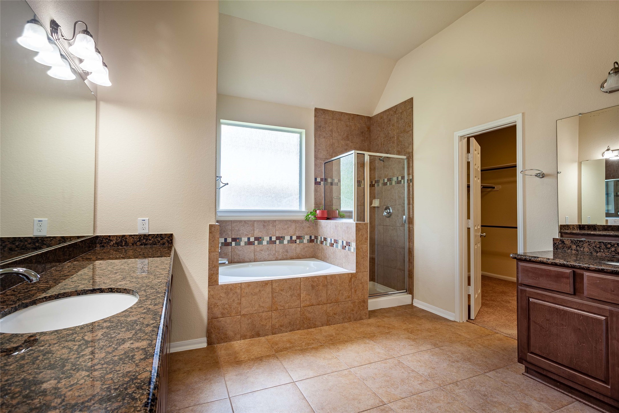 Luxurious en-suite bathroom featuring soaking tub, double sinks and shower. - If you have additional questions regarding 2404 Lakeway Drive  in Friendswood or would like to tour the property with us call 800-660-1022 and reference MLS# 35819457.
