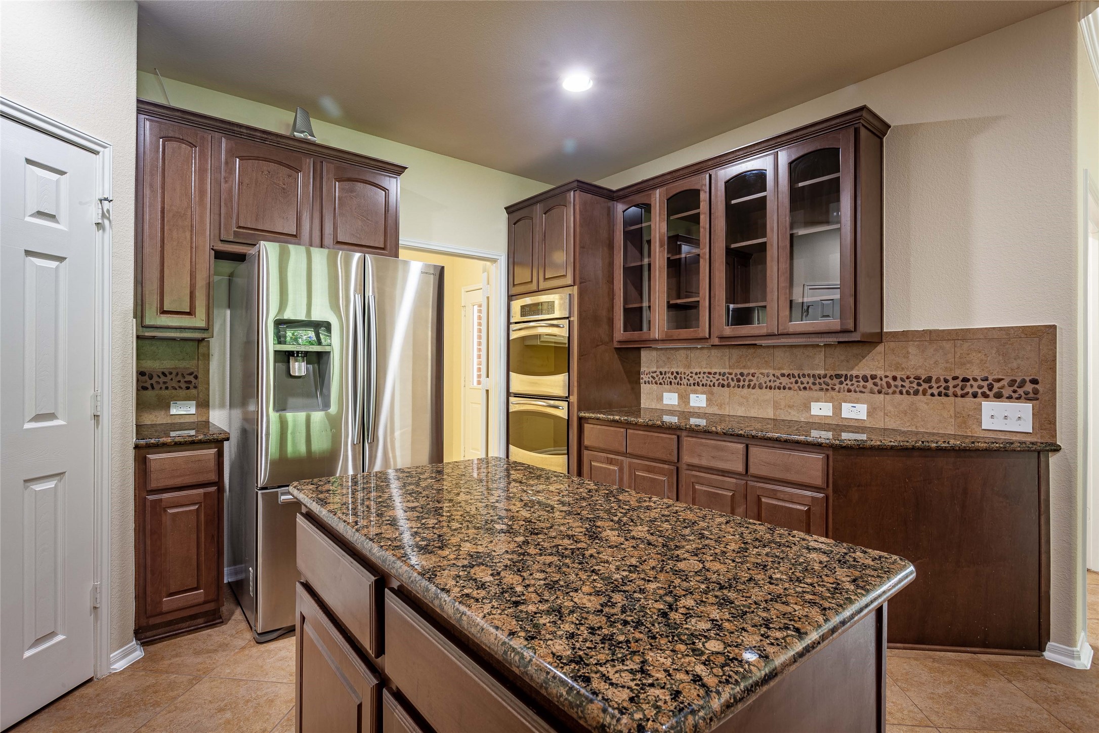 Granite counters and center island - great for entertaining. - If you have additional questions regarding 2404 Lakeway Drive  in Friendswood or would like to tour the property with us call 800-660-1022 and reference MLS# 35819457.