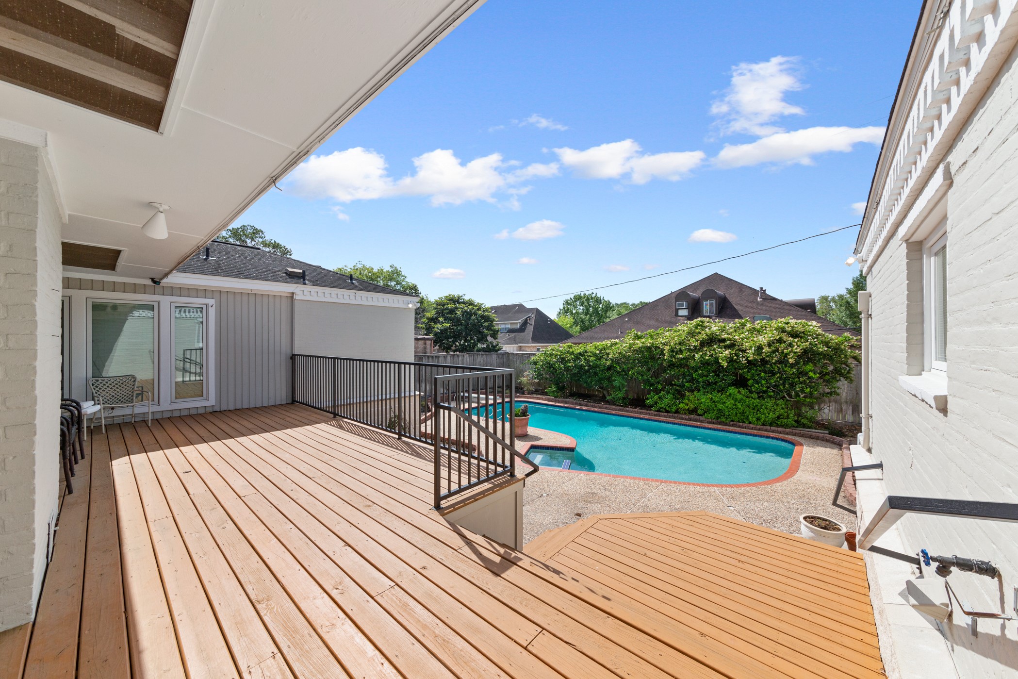 Enjoy a drink on the raised patio overlooking the inviting pool - If you have additional questions regarding 5207 Braesvalley Drive  in Houston or would like to tour the property with us call 800-660-1022 and reference MLS# 44144550.