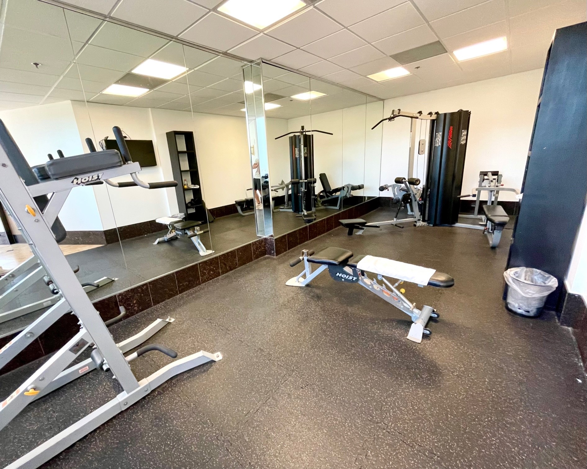 Your free weights training area complete with a bench and cable machine. - If you have additional questions regarding 3525 Sage Road  in Houston or would like to tour the property with us call 800-660-1022 and reference MLS# 79115123.