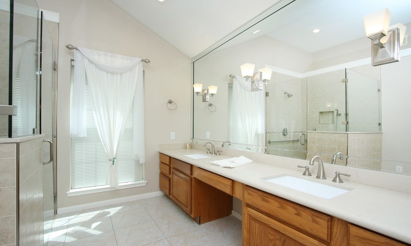 Sunny primary bath with large double sink vanity and huge mirror. - If you have additional questions regarding 8403 Colony Oaks Court  in Spring or would like to tour the property with us call 800-660-1022 and reference MLS# 21930324.