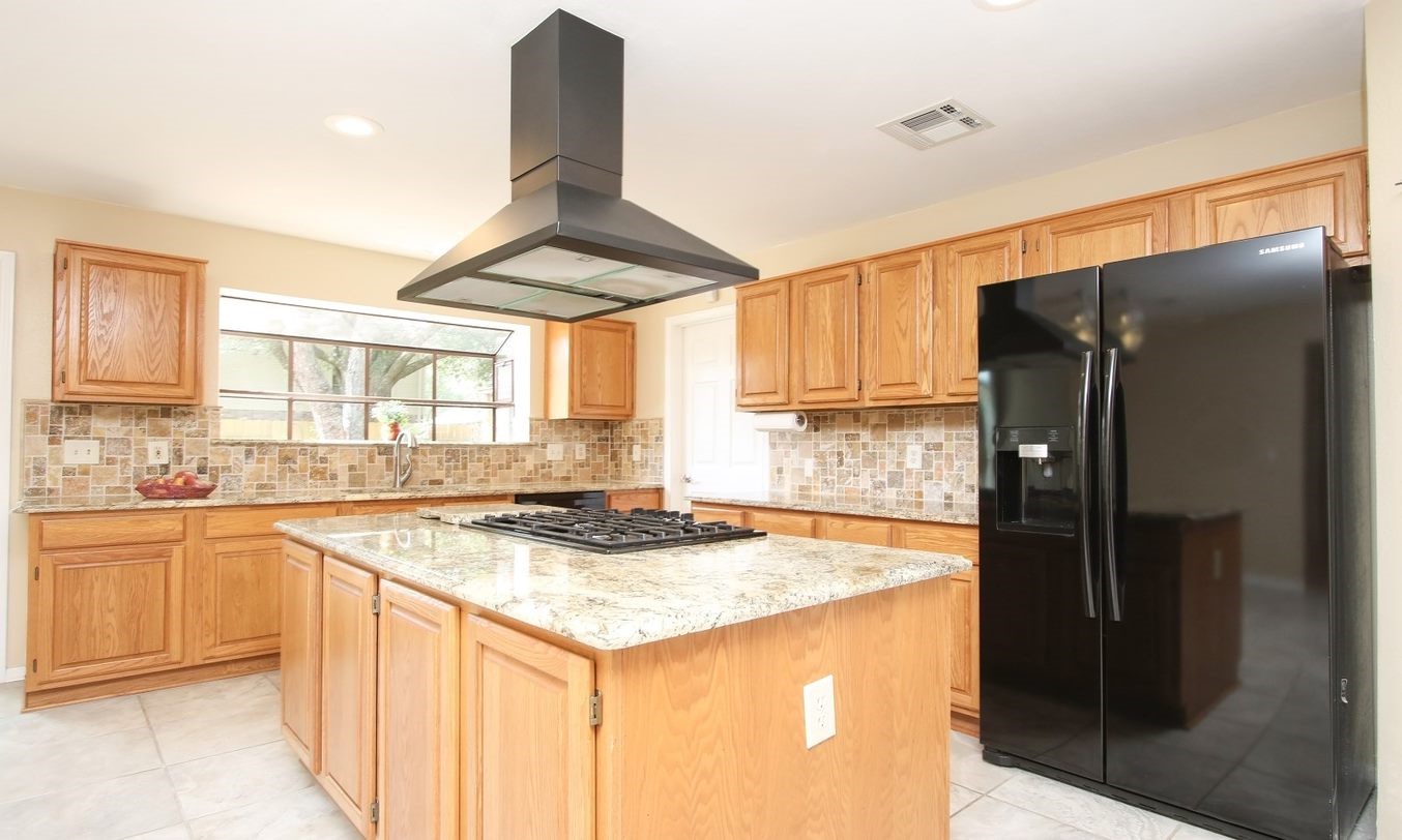 Natural light and quality finishes create a fun cooking environment. Refrigerator stays. - If you have additional questions regarding 8403 Colony Oaks Court  in Spring or would like to tour the property with us call 800-660-1022 and reference MLS# 21930324.