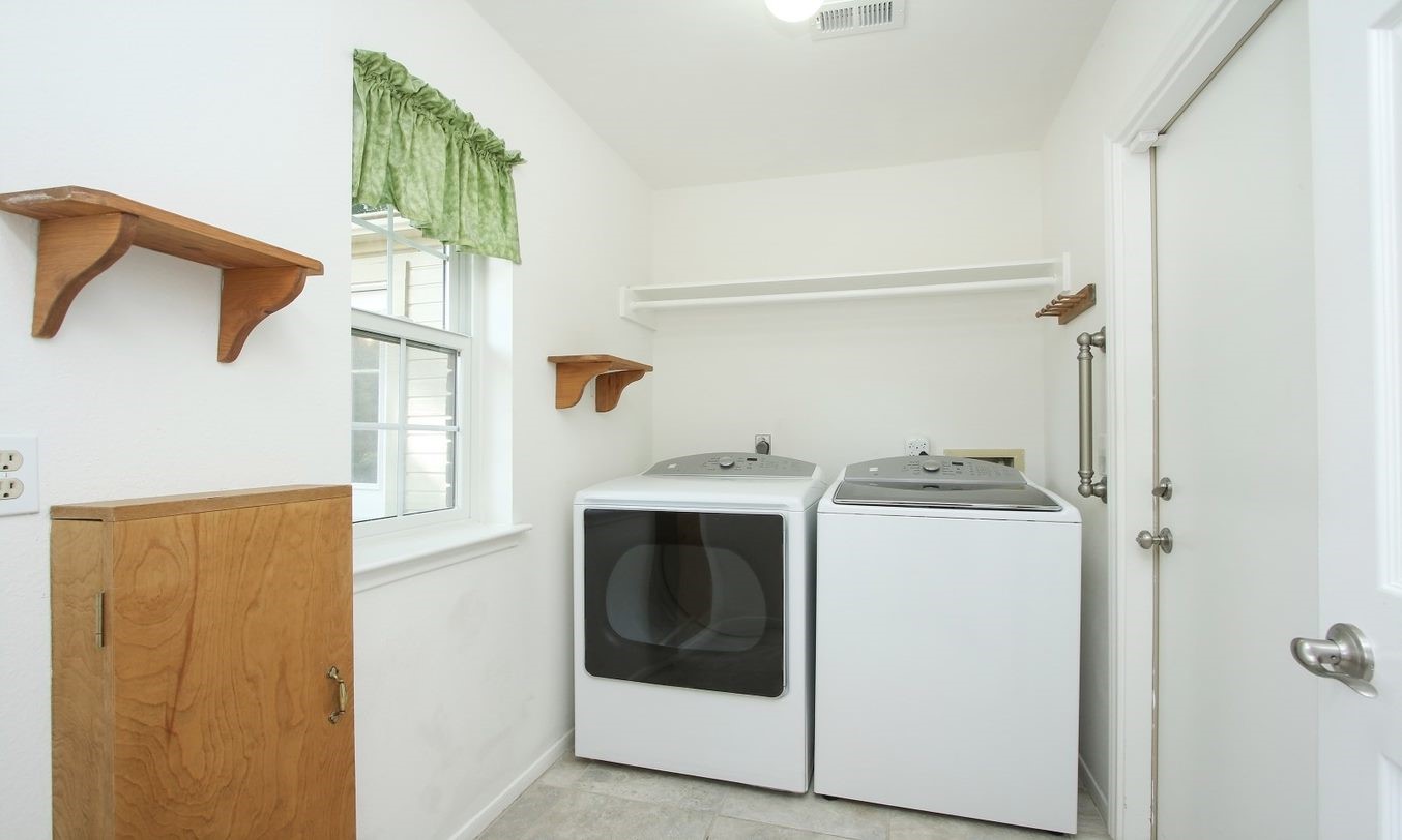 Utility room leads to oversized garage, has natural light and a fold out ironing board. Located right off the  kitchen. - If you have additional questions regarding 8403 Colony Oaks Court  in Spring or would like to tour the property with us call 800-660-1022 and reference MLS# 21930324.