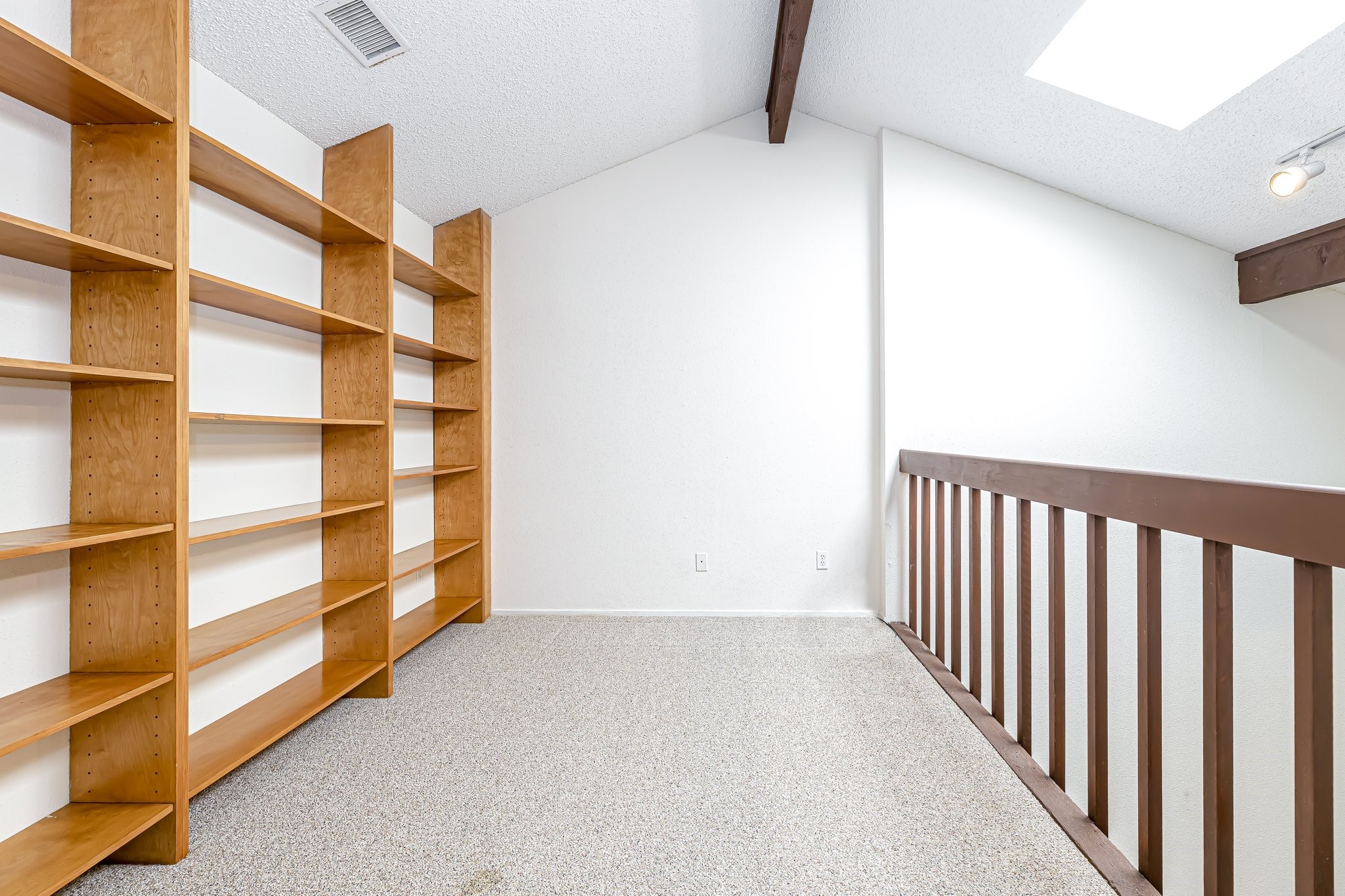 Loft area with built-in shelving leading into the upstairs bedroom. - If you have additional questions regarding 2510 Grants Lake Boulevard  in Sugar Land or would like to tour the property with us call 800-660-1022 and reference MLS# 85875014.