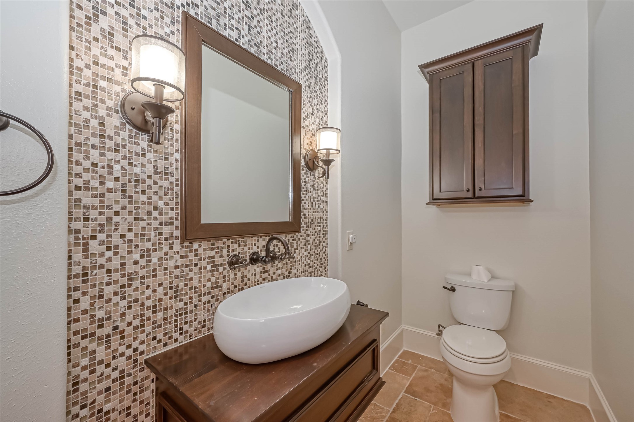 Powder room on the 2nd floor with decorative mosaic tiled wall and vessel sink - If you have additional questions regarding 6606 Rodrigo Street  in Houston or would like to tour the property with us call 800-660-1022 and reference MLS# 74006082.