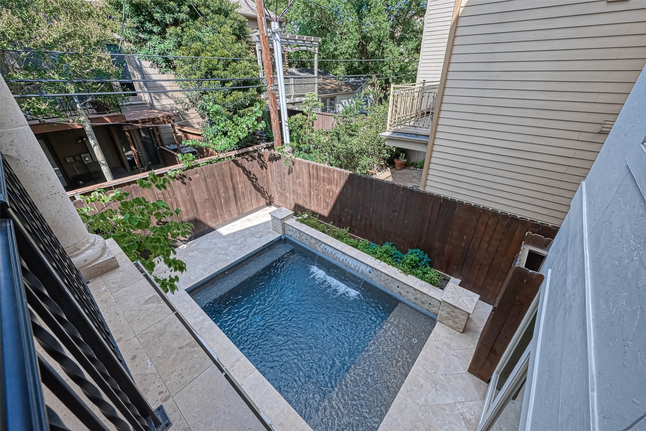 View of the pool from the balcony - If you have additional questions regarding 6606 Rodrigo Street  in Houston or would like to tour the property with us call 800-660-1022 and reference MLS# 74006082.
