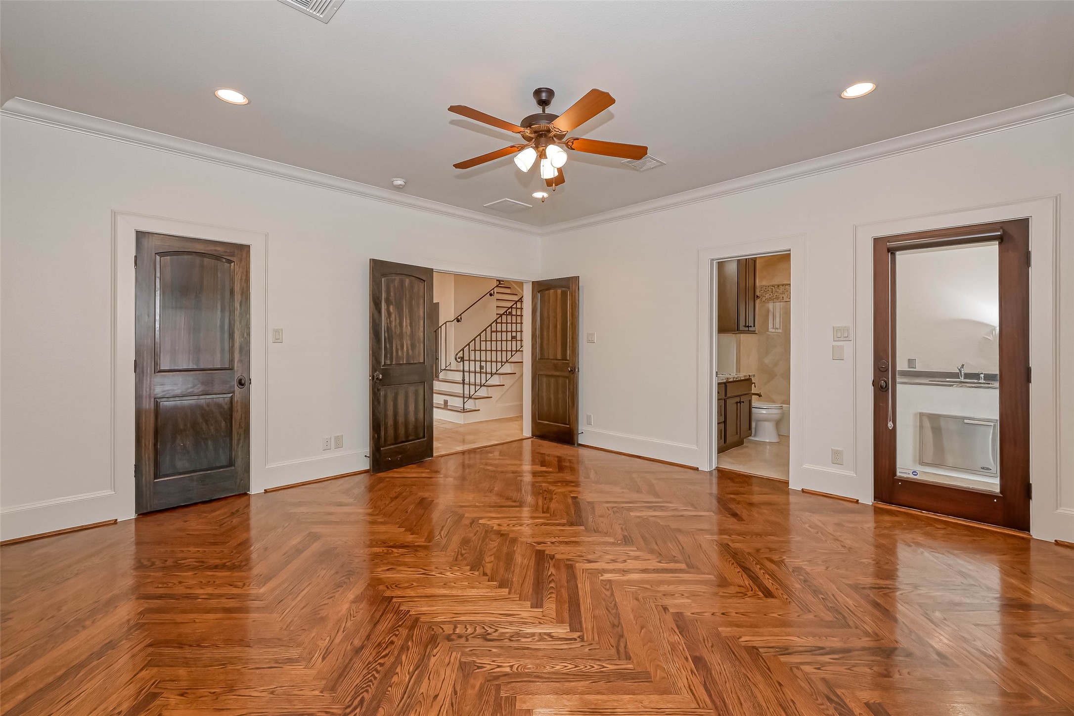 Downstairs bedroom with double doors and an ensuite.  Plus a glass door leading to the pool and outdoor kitchen - If you have additional questions regarding 6606 Rodrigo Street  in Houston or would like to tour the property with us call 800-660-1022 and reference MLS# 74006082.