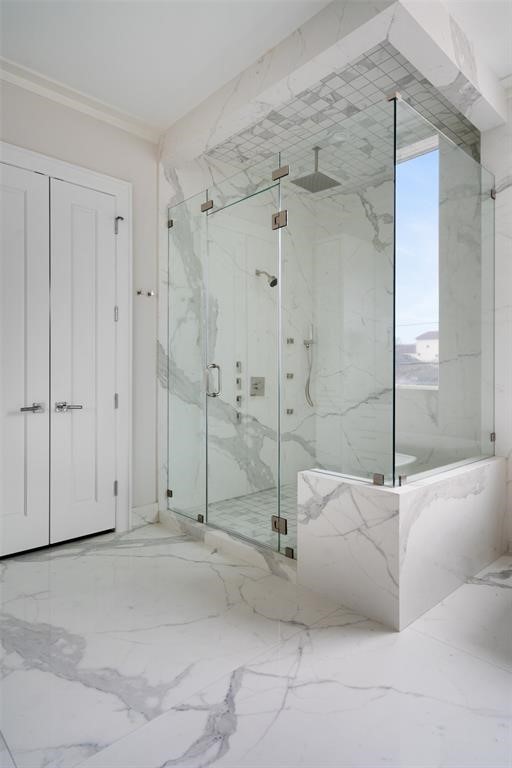 The Calacatta spa-suite shower features body sprays, an overhead rain shower head, and handheld sprayers. - If you have additional questions regarding 2514 Avalon Place  in Houston or would like to tour the property with us call 800-660-1022 and reference MLS# 13685198.