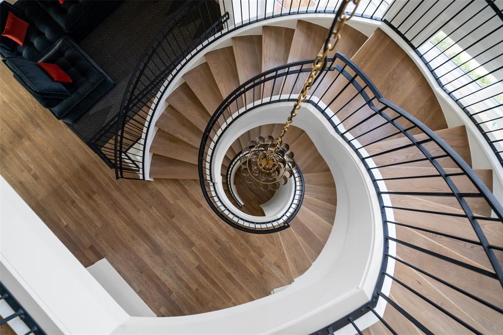 The home's iconic floating staircase features Restoration Hardware lighting including a handmade dropped cathedral brass chandelier and RH wall sconces. - If you have additional questions regarding 2514 Avalon Place  in Houston or would like to tour the property with us call 800-660-1022 and reference MLS# 13685198.