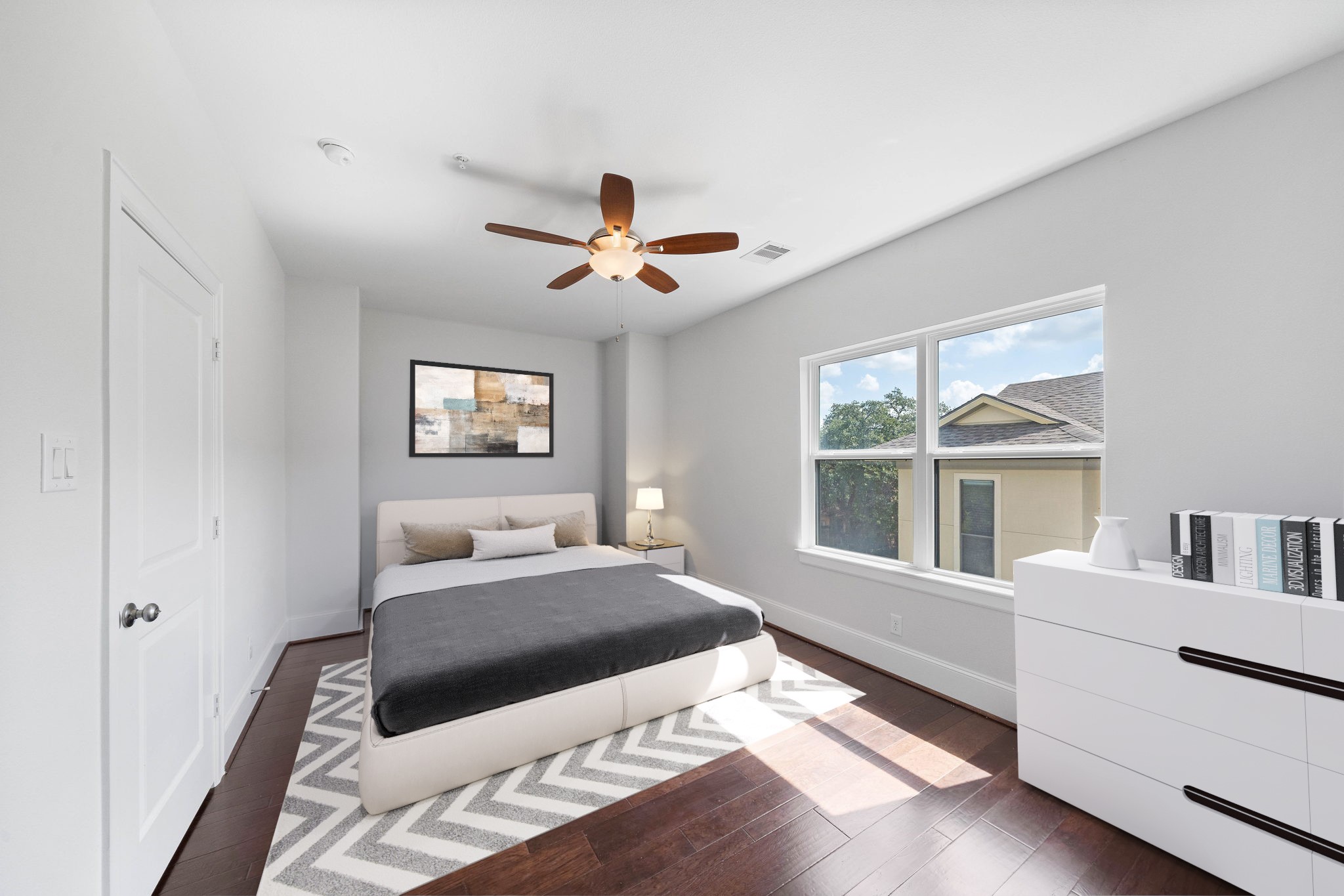 Intimate second bedroom with ceiling fan and hardwood flooring.(virtual staged) - If you have additional questions regarding 2433 Dorrington Street  in Houston or would like to tour the property with us call 800-660-1022 and reference MLS# 30508451.