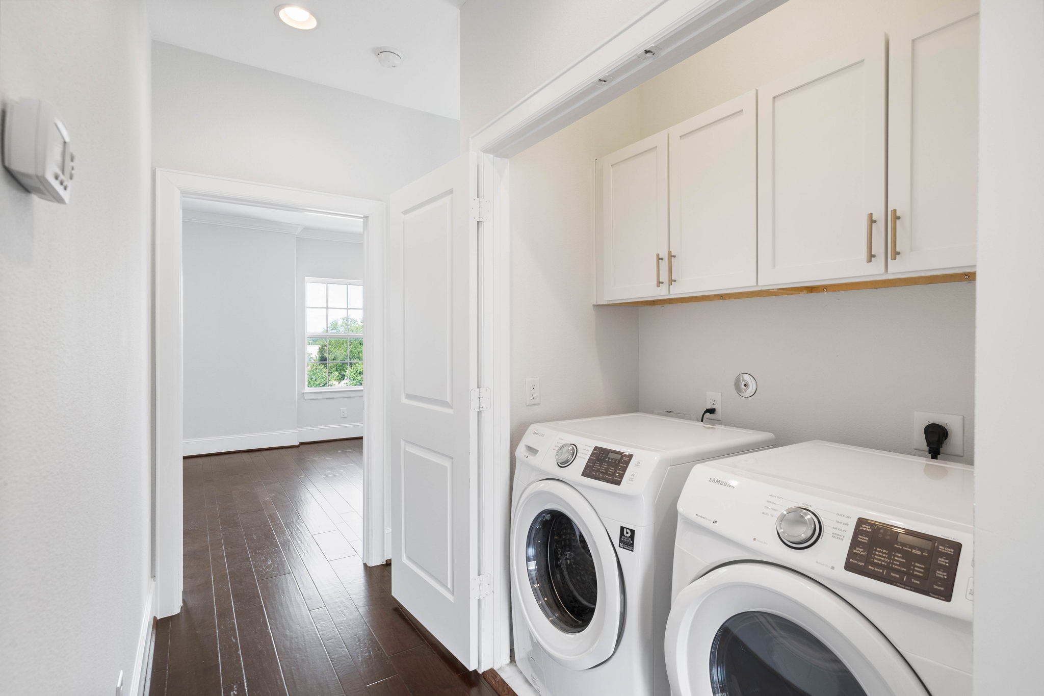 in house utility room with customized cabinets. - If you have additional questions regarding 2433 Dorrington Street  in Houston or would like to tour the property with us call 800-660-1022 and reference MLS# 30508451.