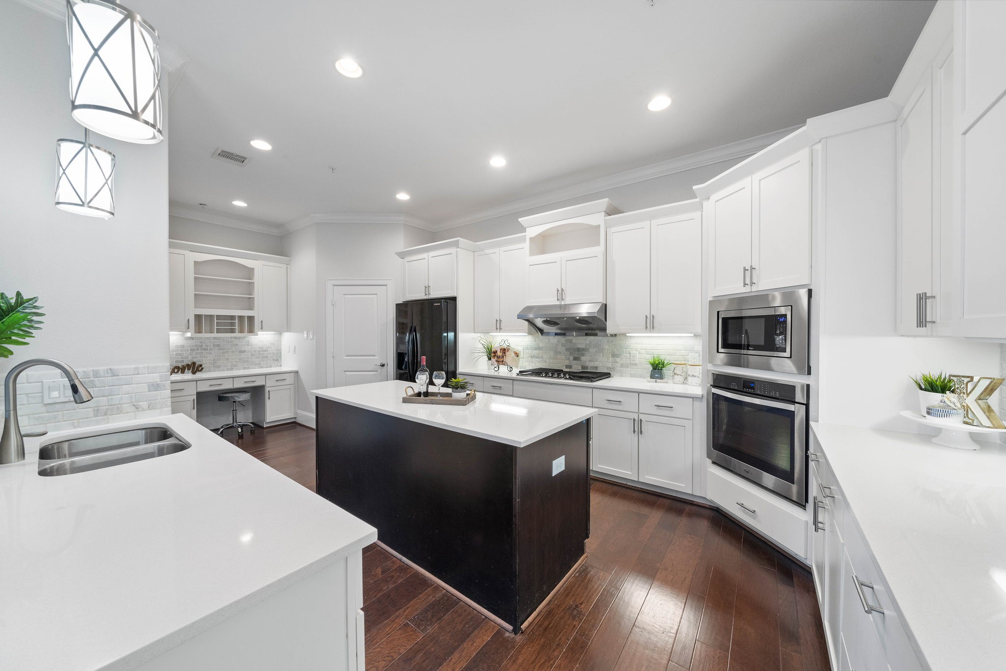 This kitchen is equipped with stainless steel appliances and additional workspace with fancy light fixtures. - If you have additional questions regarding 2433 Dorrington Street  in Houston or would like to tour the property with us call 800-660-1022 and reference MLS# 30508451.