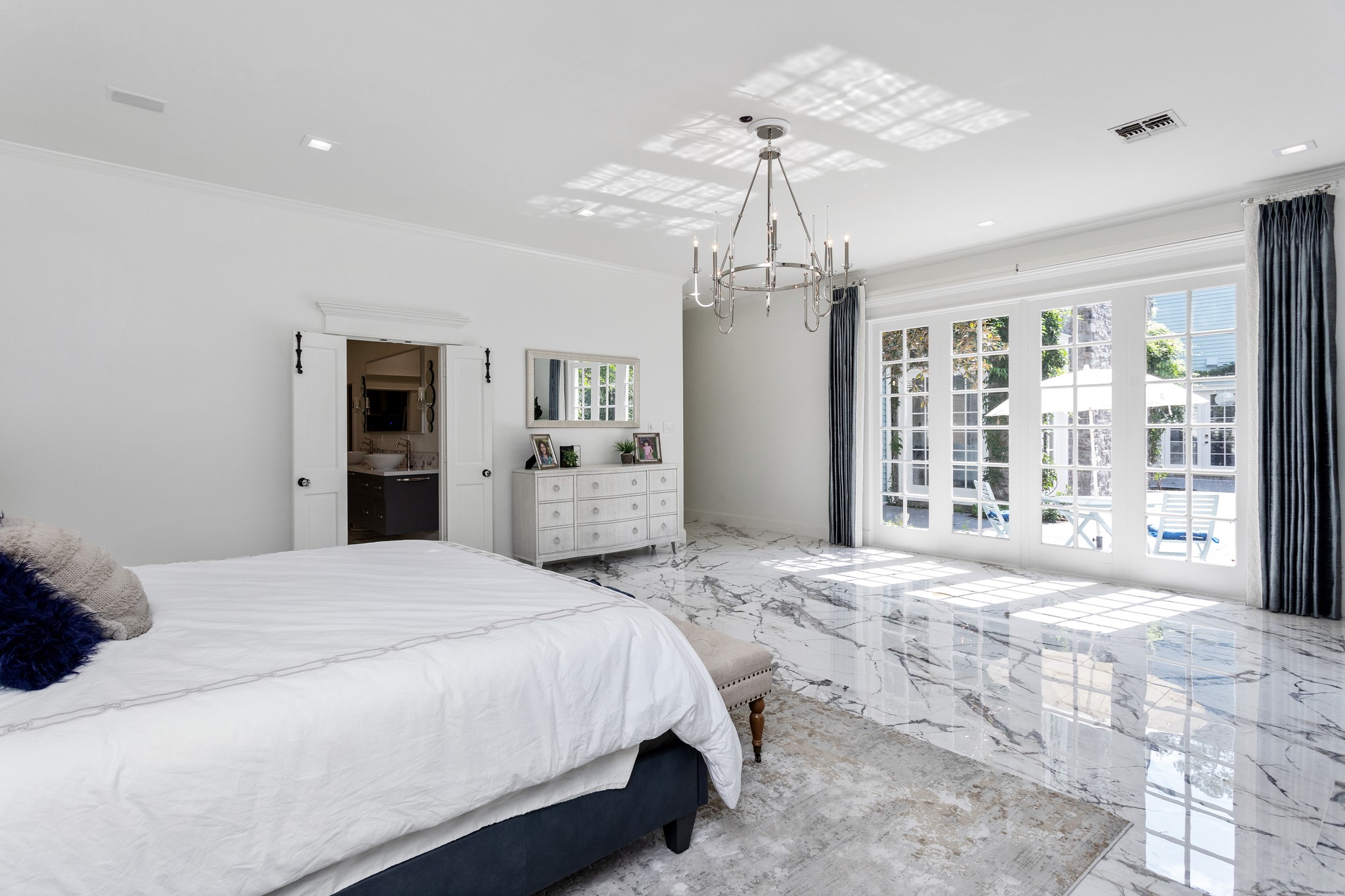 Alternative view of the primary bedroom with natural light leading into the primary bathroom with his and her closets. - If you have additional questions regarding 621 Piney Point Road  in Houston or would like to tour the property with us call 800-660-1022 and reference MLS# 94401037.