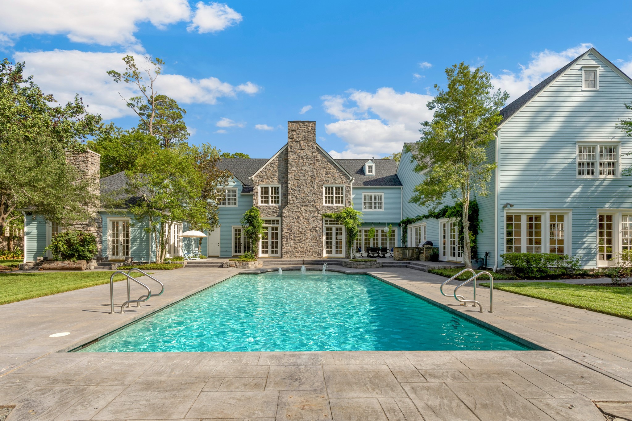 View of the back of the estate with oversized pool. The house is perfectly situated on 1.2 Acres in the middle of Piney Point. - If you have additional questions regarding 621 Piney Point Road  in Houston or would like to tour the property with us call 800-660-1022 and reference MLS# 94401037.