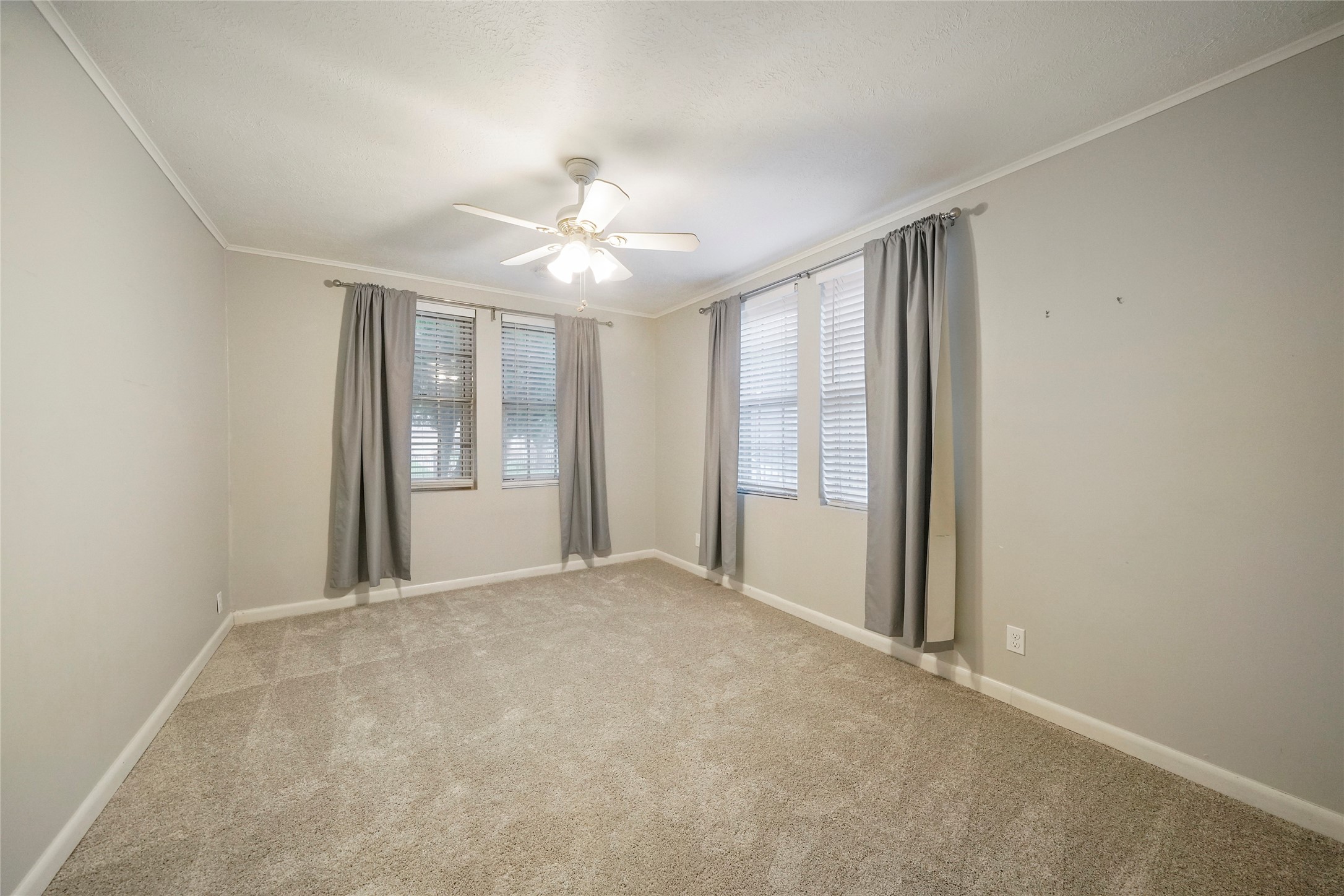 Guest bedroom with new carpet, neutral paint and large windows. - If you have additional questions regarding 1118 Peddie Street  in Houston or would like to tour the property with us call 800-660-1022 and reference MLS# 17025170.