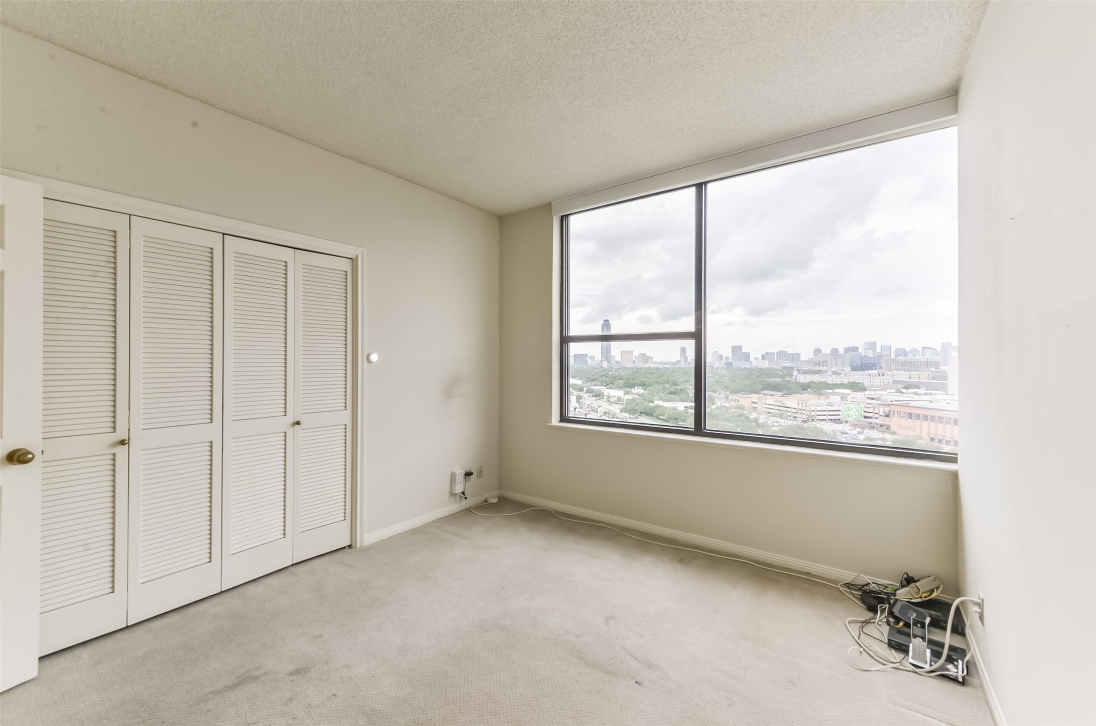 A secondary bedroom enjoys sweeping vistas to the west. - If you have additional questions regarding 14 Greenway Plaza  in Houston or would like to tour the property with us call 800-660-1022 and reference MLS# 26451519.