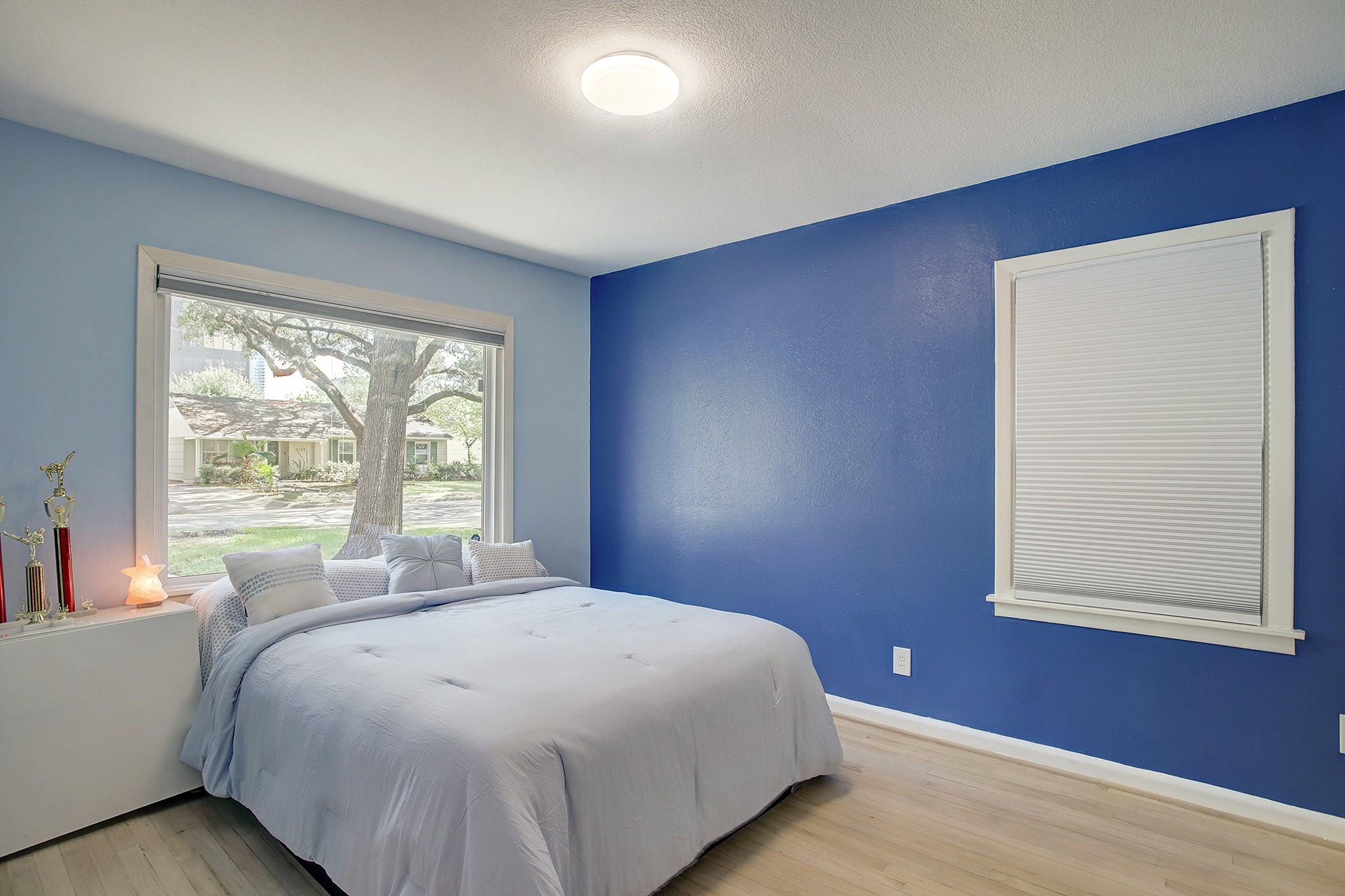 Large windows on two sides of this bedroom provide a view of the majestic shade trees  and provide so much natural light. All bedrooms have nice sized windows and custom closets. - If you have additional questions regarding 4115 Portsmouth Avenue  in Houston or would like to tour the property with us call 800-660-1022 and reference MLS# 68935883.