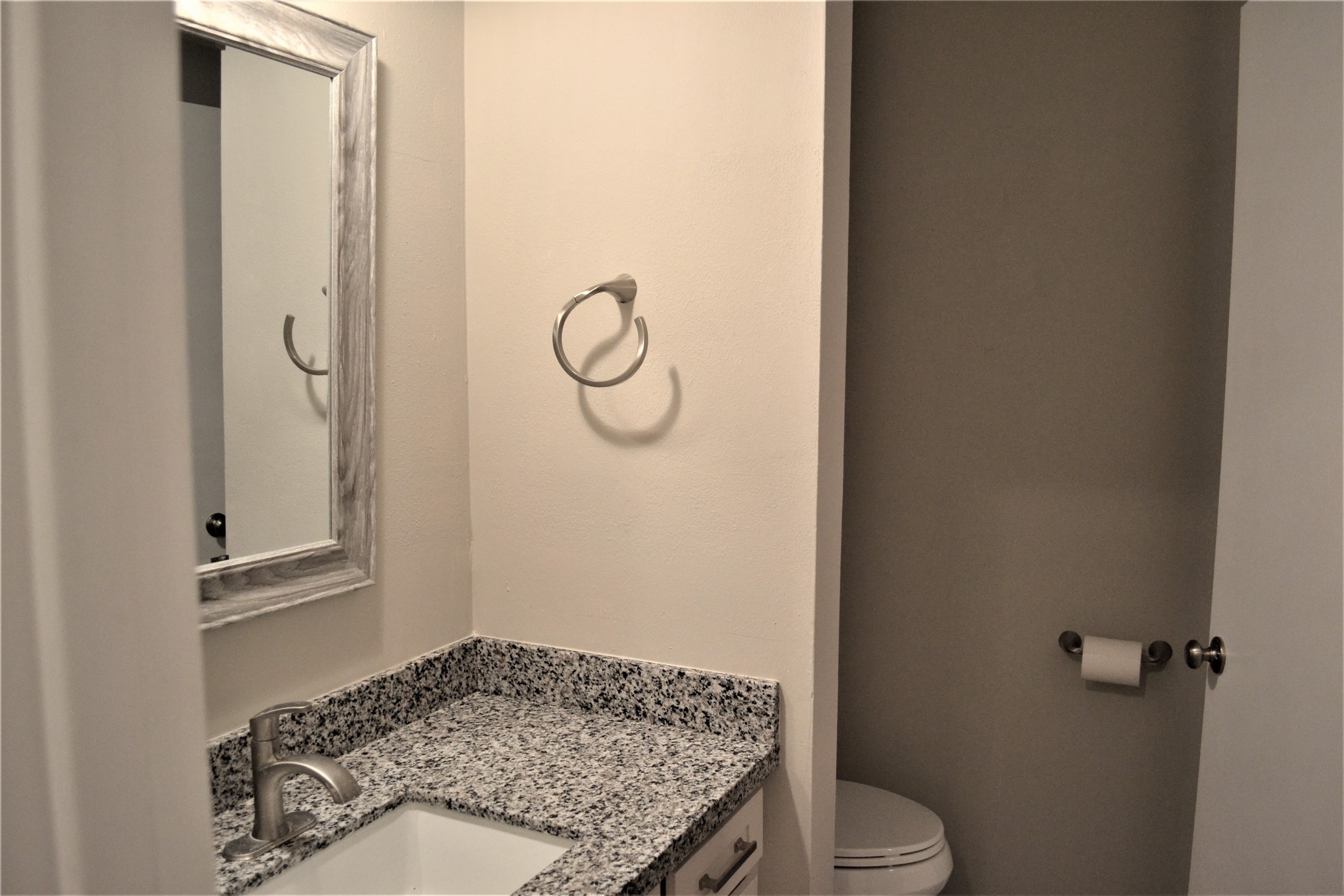 One of the remodeled vanity areas with granite counters, and attached toilet area. - If you have additional questions regarding 9322 Olathe Street  in Houston or would like to tour the property with us call 800-660-1022 and reference MLS# 48770450.