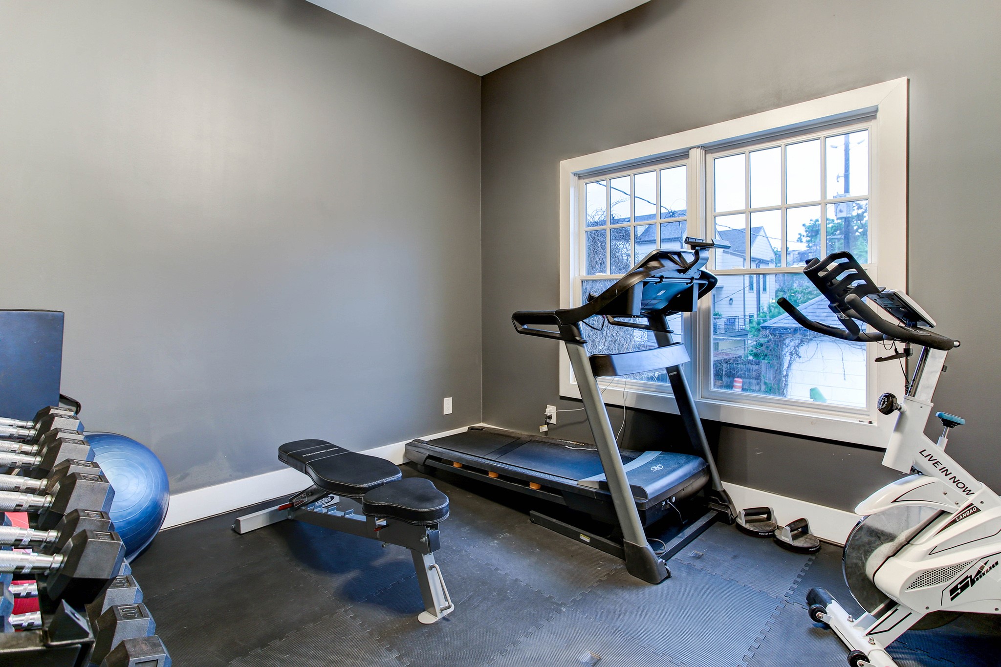 Second bedroom in guest quarters currently being used as a gym. - If you have additional questions regarding 204 Stratford Street  in Houston or would like to tour the property with us call 800-660-1022 and reference MLS# 27628379.