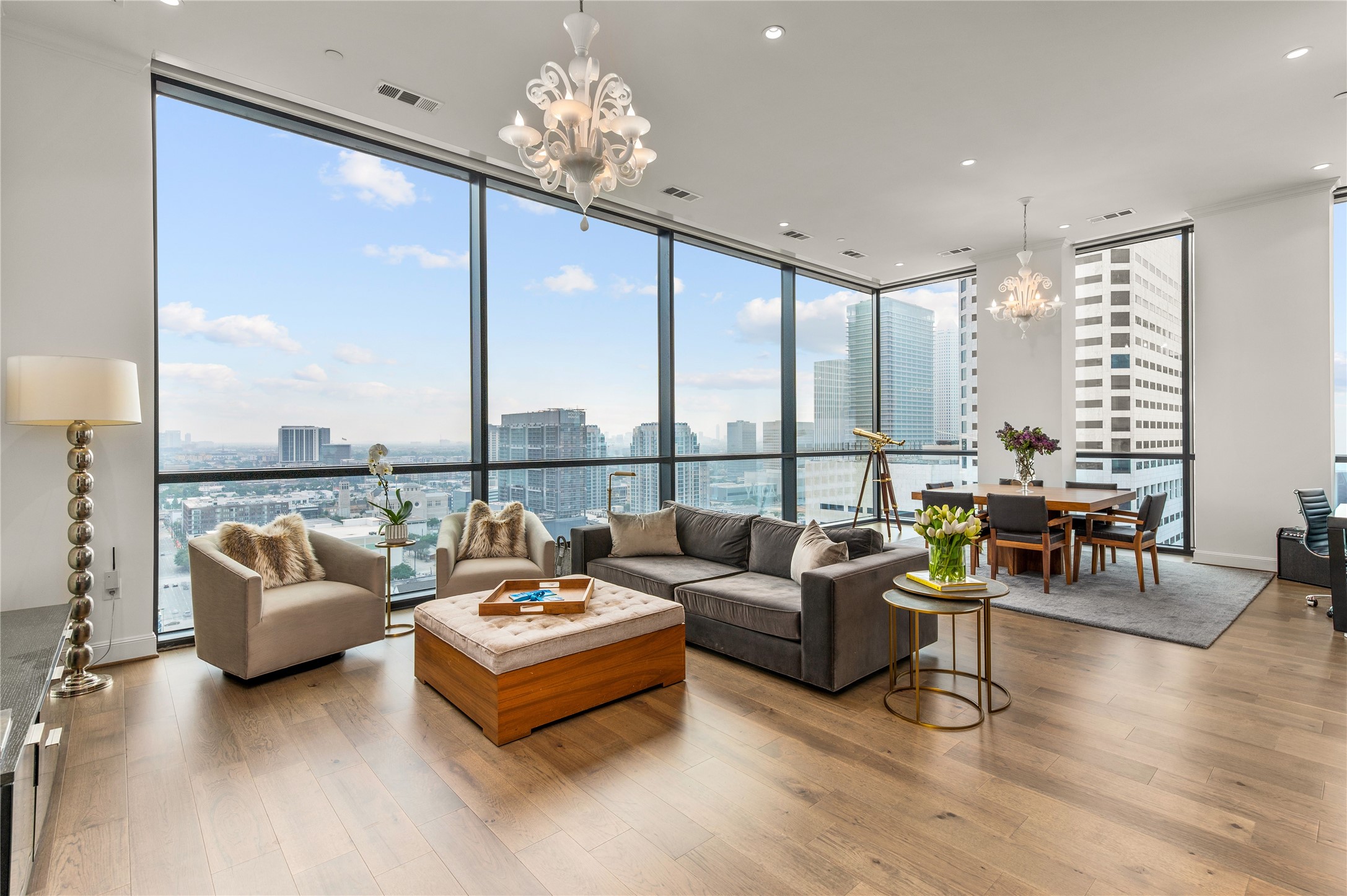 Living Room with a View, 12 foot ceiling and motorized shades. - If you have additional questions regarding 1211 Caroline Street  in Houston or would like to tour the property with us call 800-660-1022 and reference MLS# 32313448.