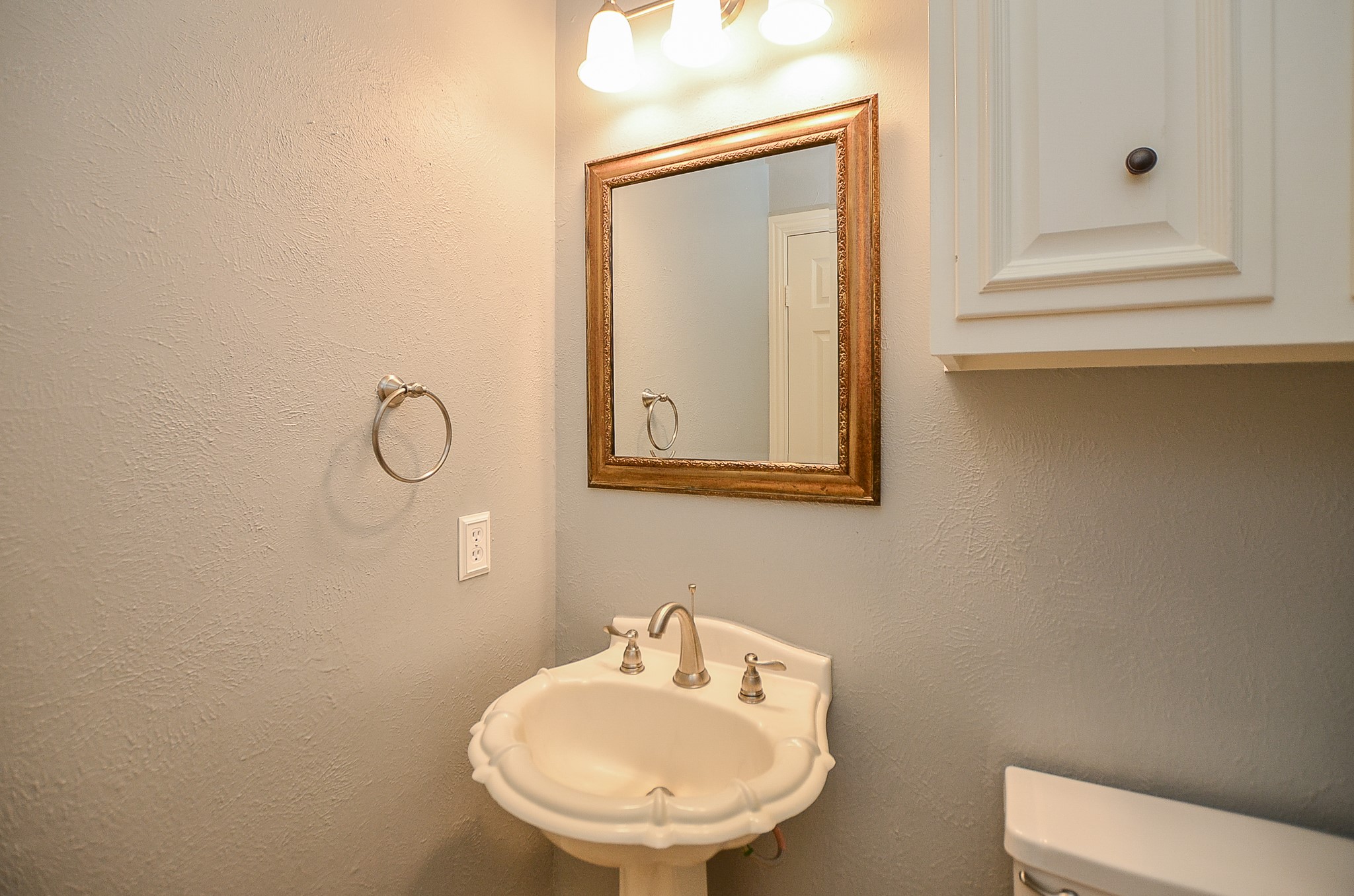 Downstairs is the powder bathroom with pedestal sink. - If you have additional questions regarding 5538 Honor Drive  in Houston or would like to tour the property with us call 800-660-1022 and reference MLS# 55987326.