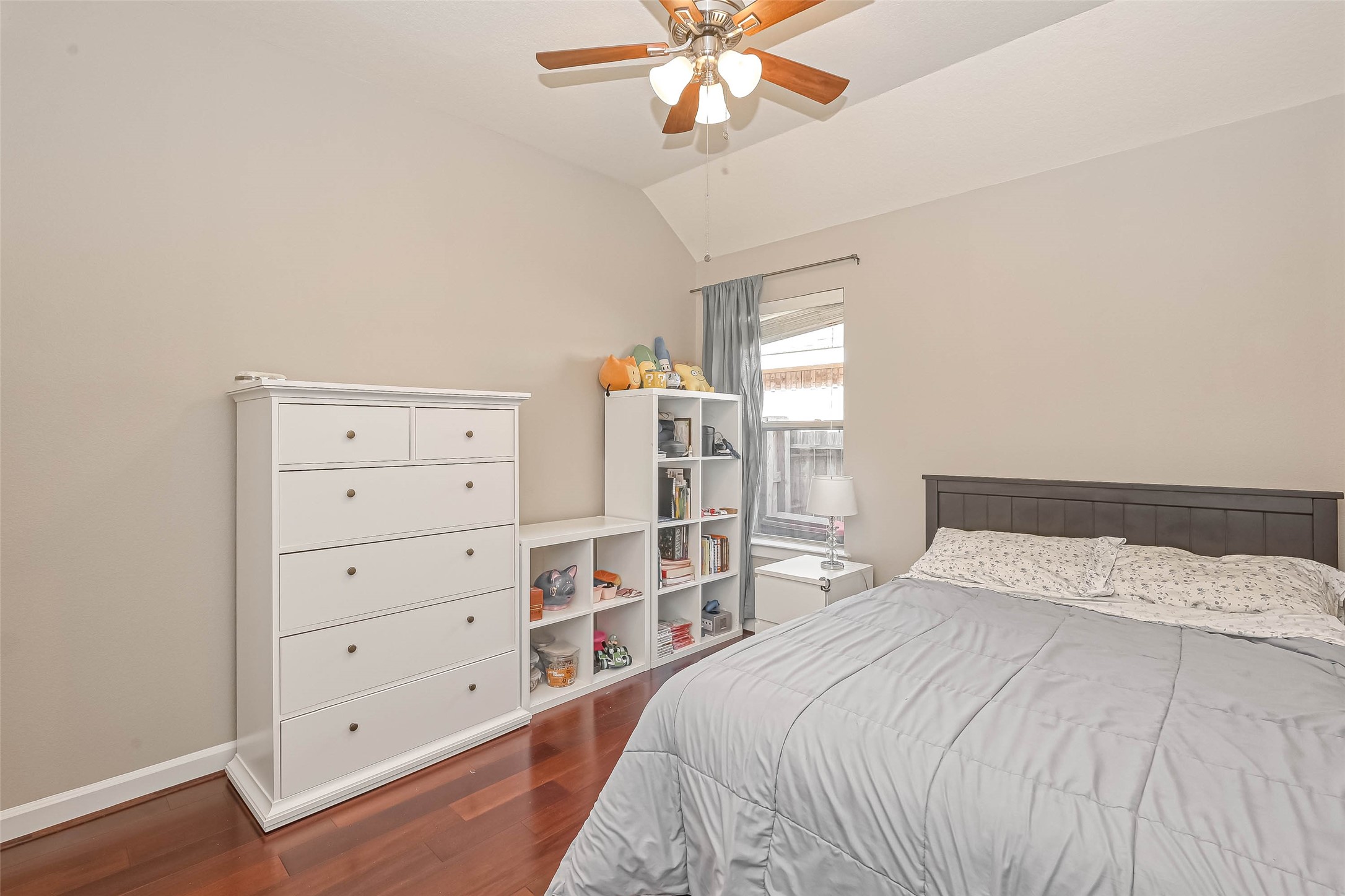 Secondary bedroom - one of two.  Same wood floors & notice ceiling fan & vaulted ceiling. - If you have additional questions regarding 5531 Barleycorn Lane  in Katy or would like to tour the property with us call 800-660-1022 and reference MLS# 26035060.
