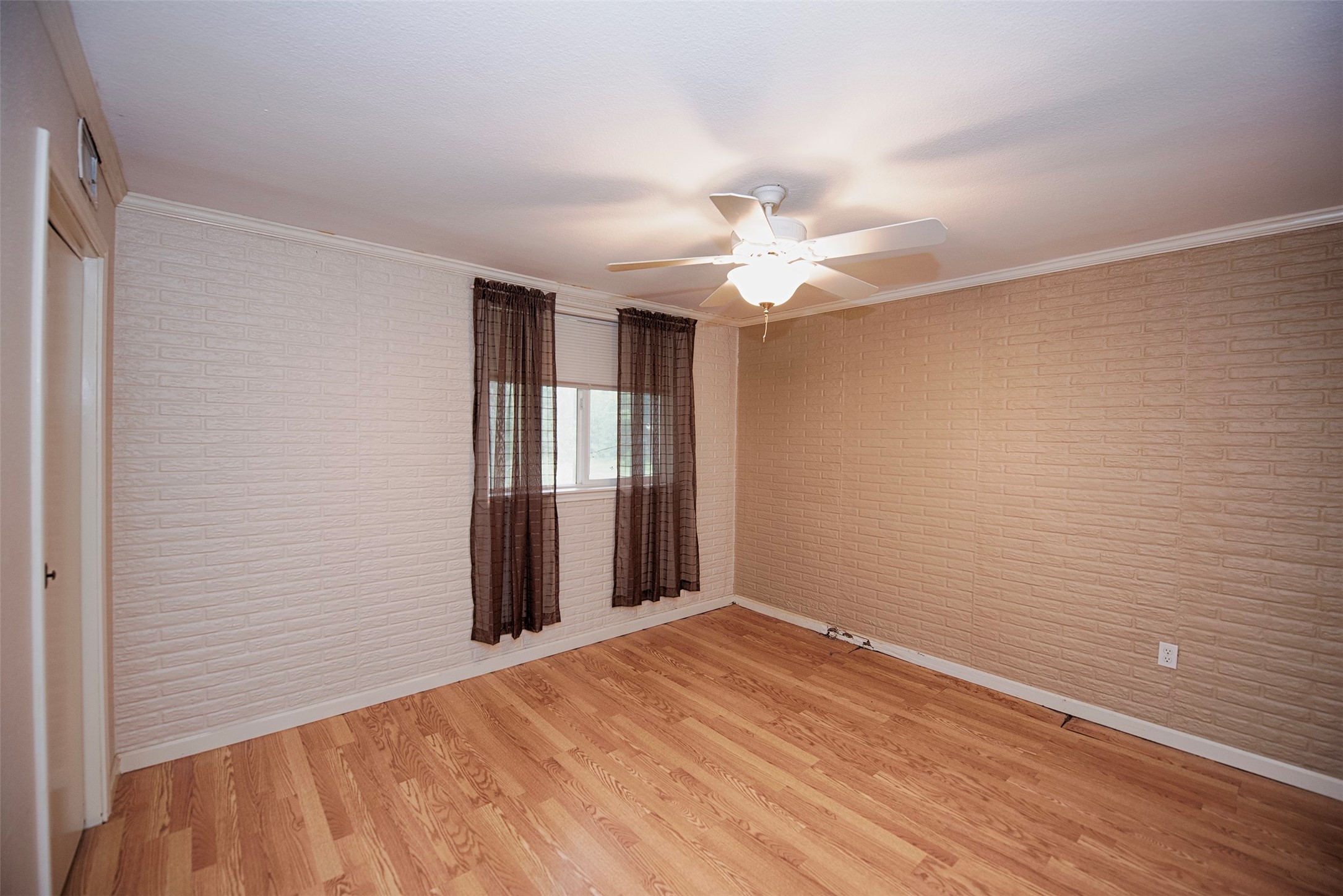 Another spacious bedroom with two brick walls. Perfect room for your guests. - If you have additional questions regarding 1028 N Country Club Drive  in Shoreacres or would like to tour the property with us call 800-660-1022 and reference MLS# 5487846.