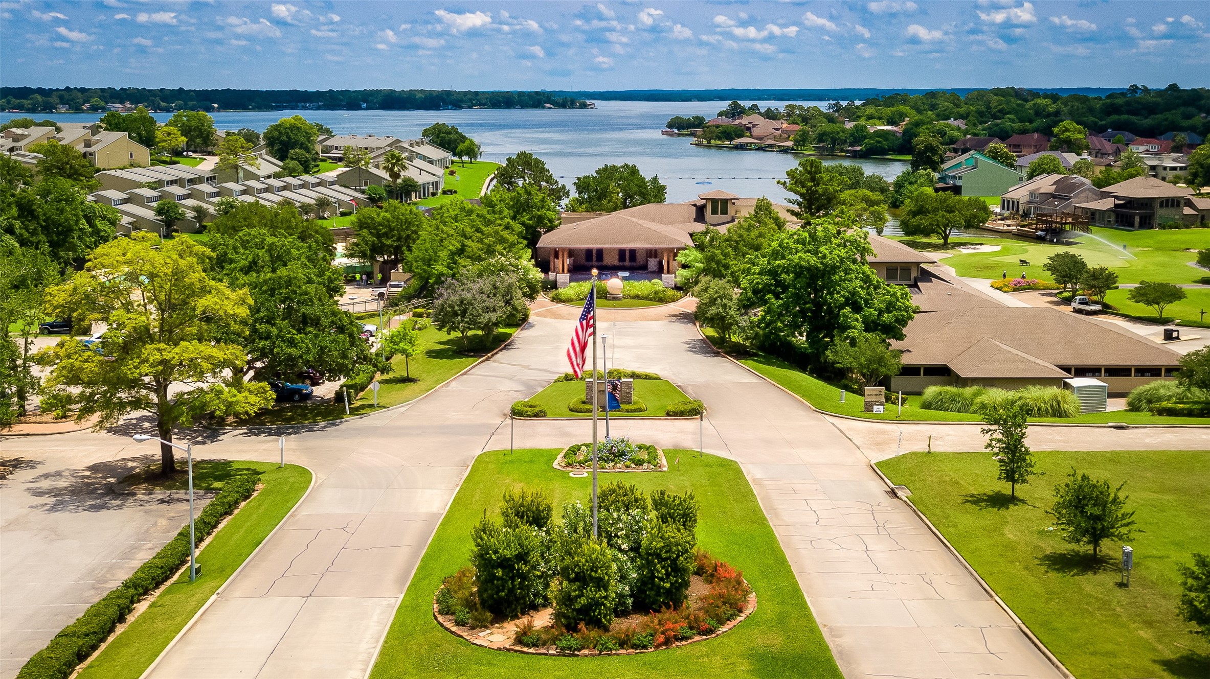 View of April Sound Boulevard, Country Club and golf shop overlooking Lake Conroe - If you have additional questions regarding 190 Park Way  in Montgomery or would like to tour the property with us call 800-660-1022 and reference MLS# 70087213.