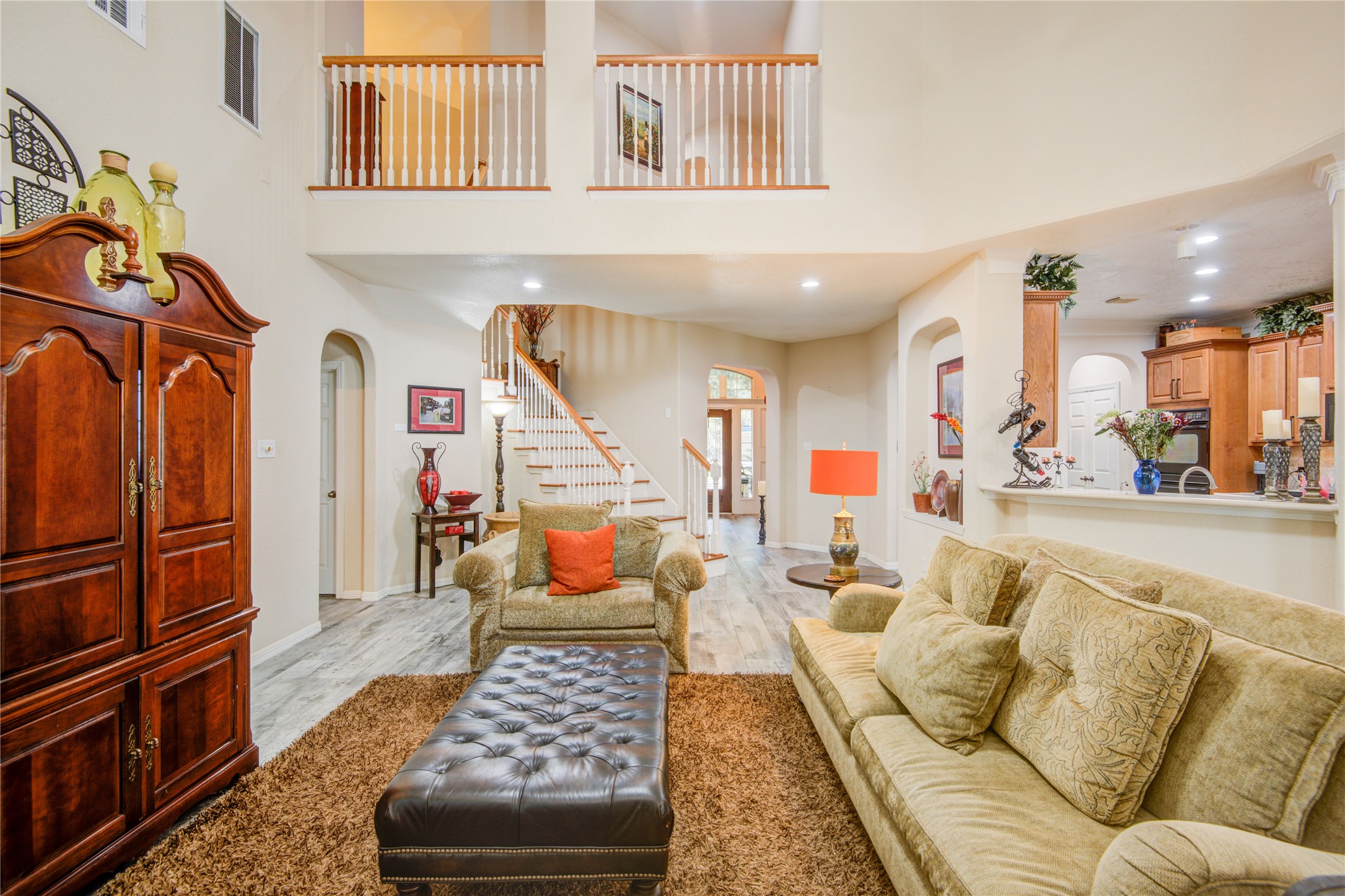 A view of living room and upstairs banister. - If you have additional questions regarding 1111 Chelshurst Way  in Spring or would like to tour the property with us call 800-660-1022 and reference MLS# 54717444.