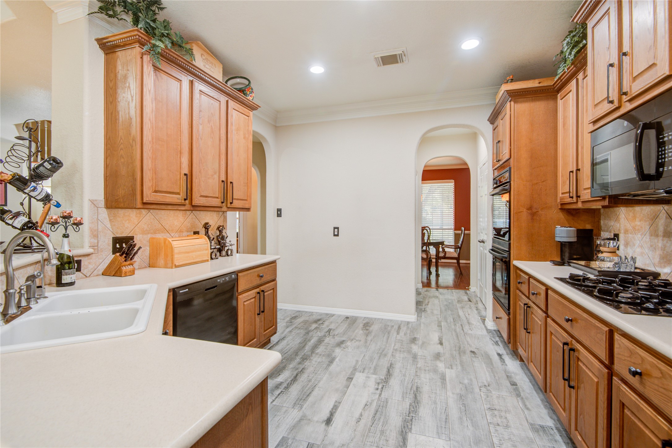 View of the kitchen leading to the formal dining room. - If you have additional questions regarding 1111 Chelshurst Way  in Spring or would like to tour the property with us call 800-660-1022 and reference MLS# 54717444.