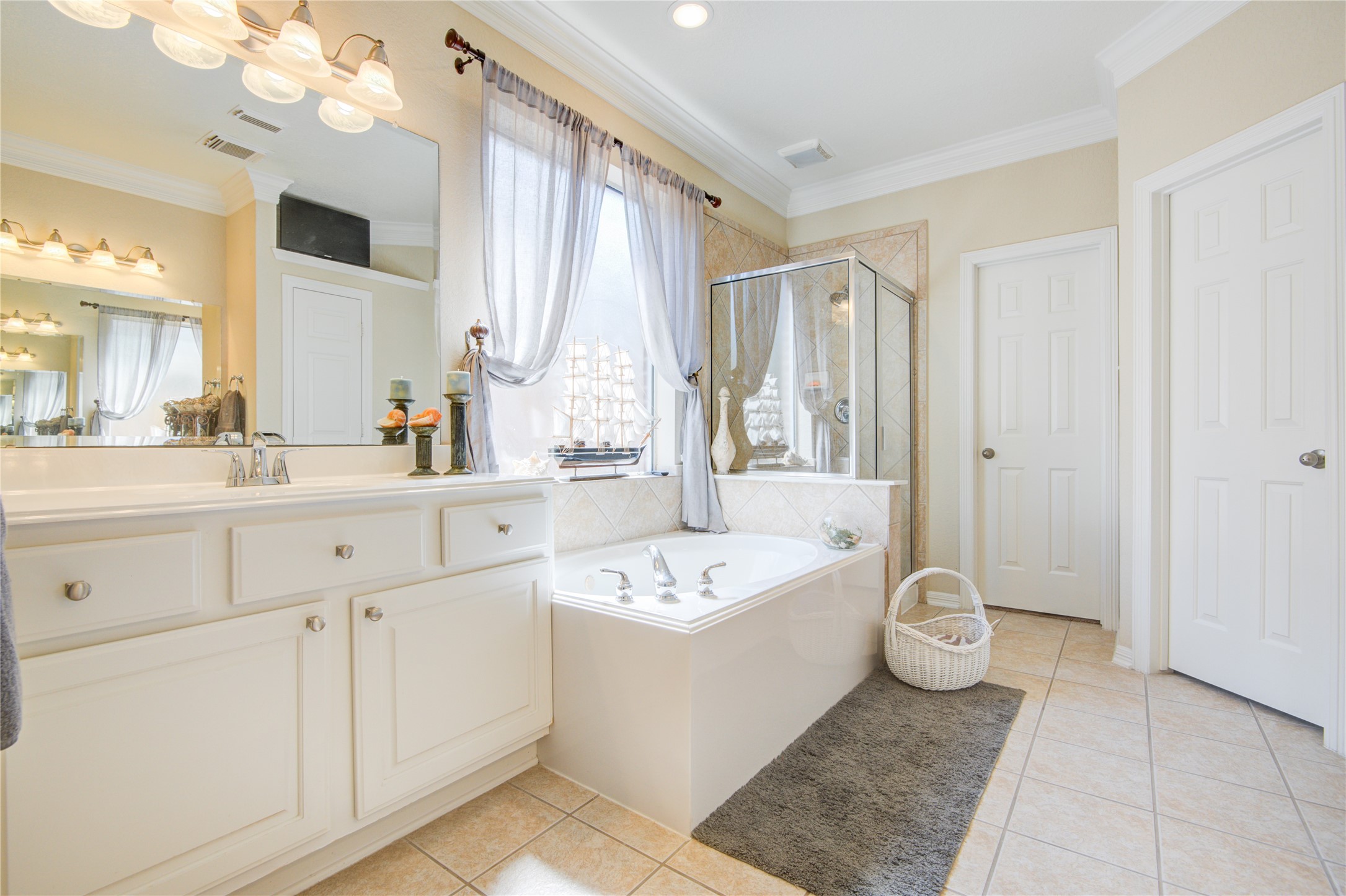 This oversized master bathroom is equipped with all of your needs.  This bathroom includes tile flooring, natural lighting, two separate vanities, linen closet, walk-in closet, a whirlpool tub and separate shower. - If you have additional questions regarding 1111 Chelshurst Way  in Spring or would like to tour the property with us call 800-660-1022 and reference MLS# 54717444.