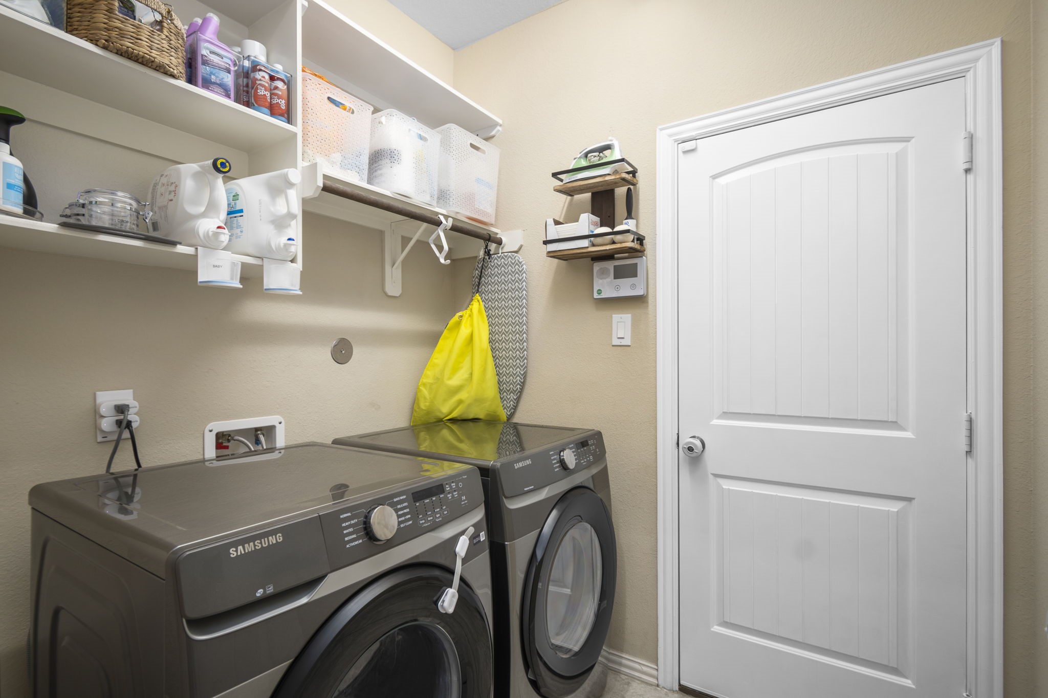 Utility/Laundry Room with Garage Door in Background - If you have additional questions regarding 7423 Simpson Springs Lane  in Spring or would like to tour the property with us call 800-660-1022 and reference MLS# 15164487.