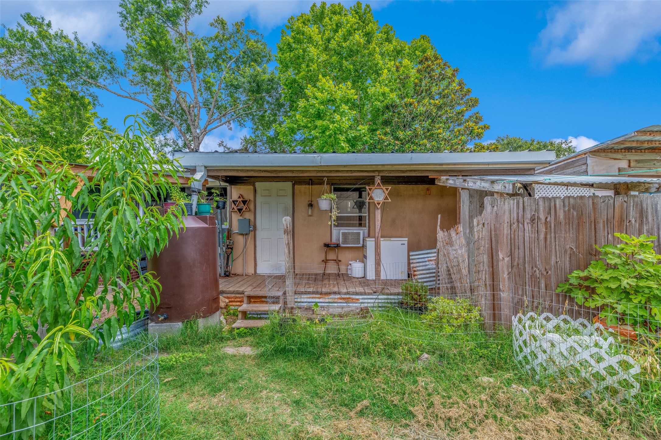 VIEW OF TINY SPACE BEHIND MOBILE HOME - If you have additional questions regarding 2055 Green Meadows Drive  in Sealy or would like to tour the property with us call 800-660-1022 and reference MLS# 16848431.